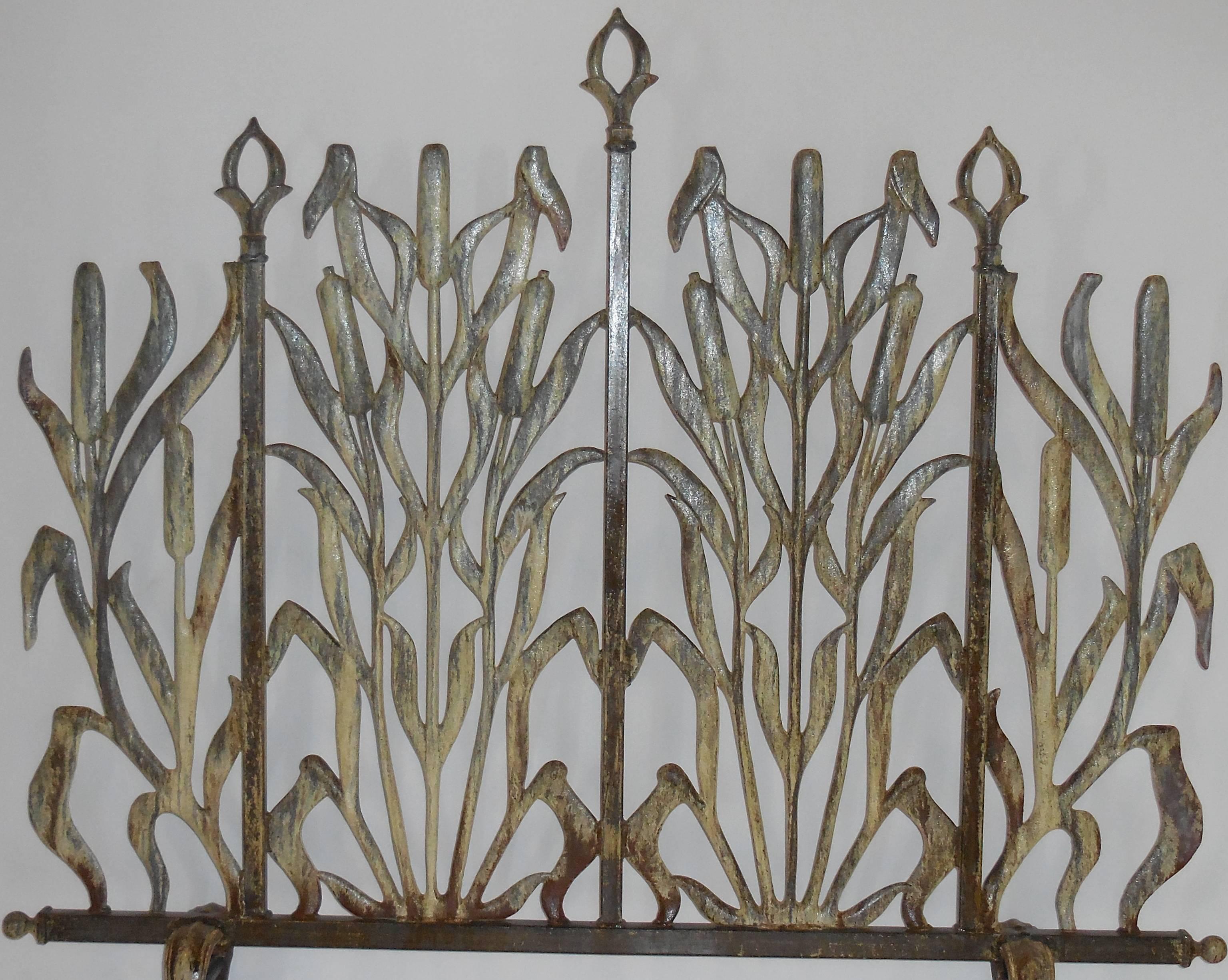 One of a Kind fireplace screen made of cast iron with decorative motif of cat tail
and arrows.
Great patina.