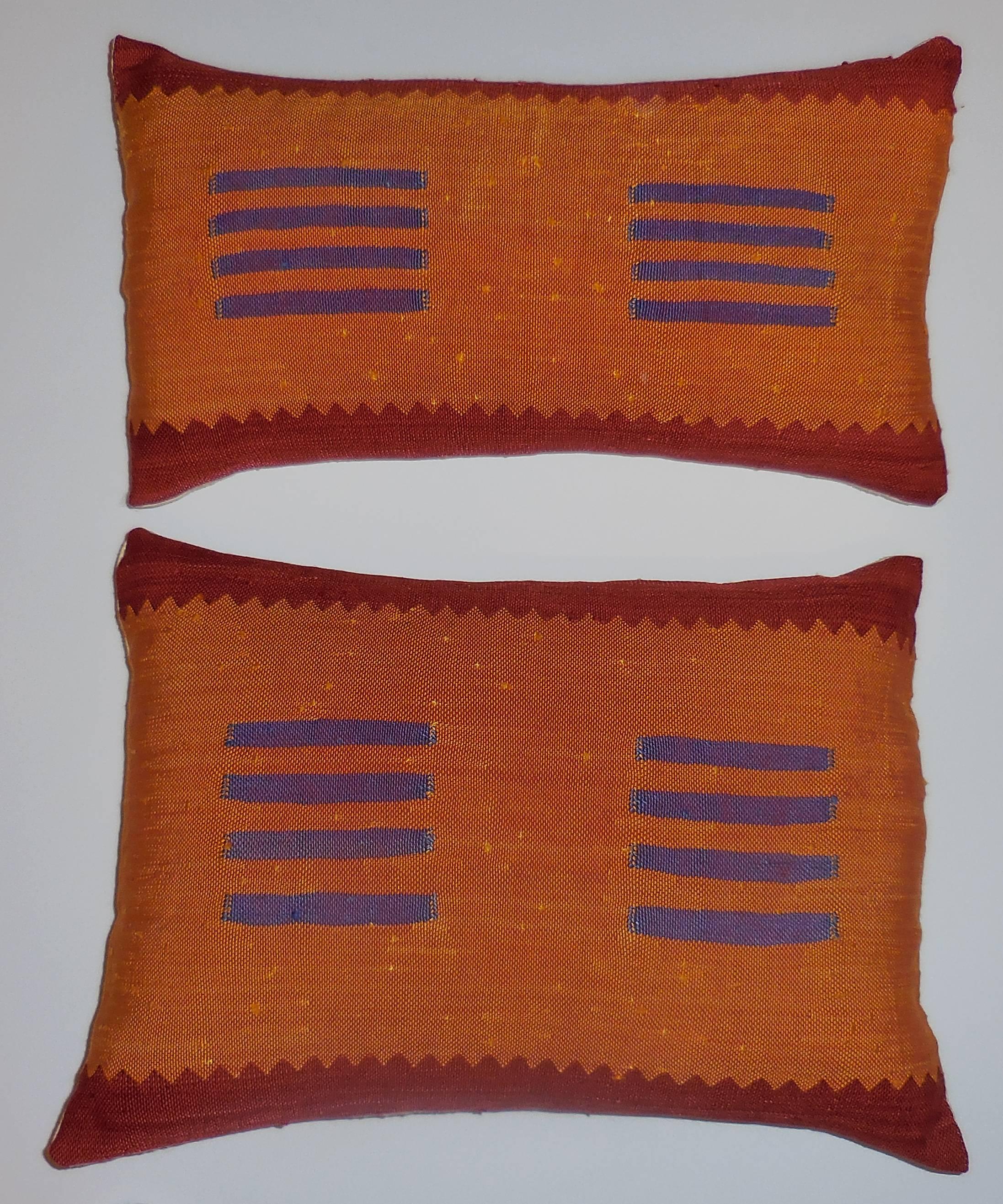 Beautiful pair of pillows made of hand-woven silk. Multi-color geometric motif on lightly red-crimson, orange and purple colors. Silk backing and new inserts. Size: First pillow 20