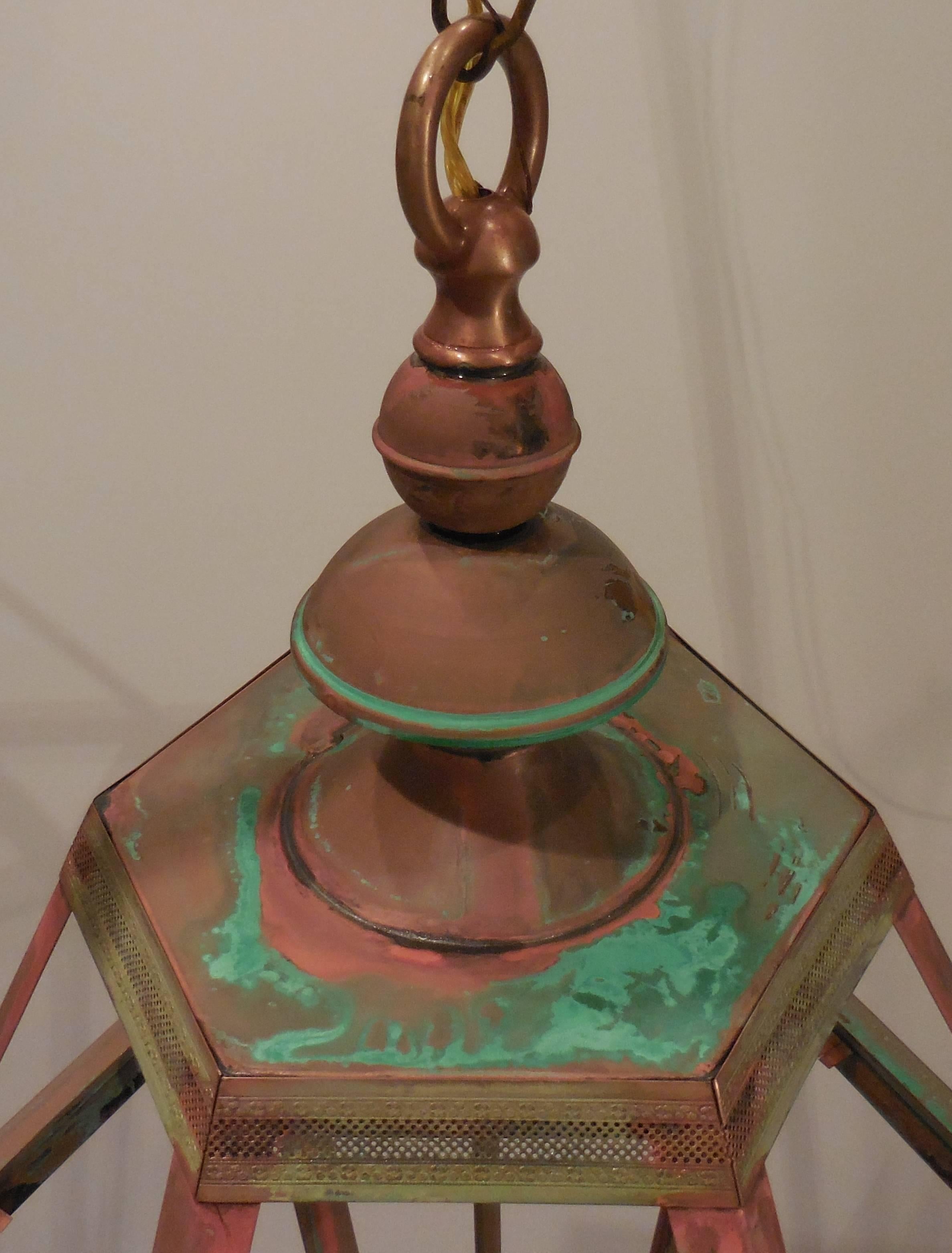 Elegant large lantern made of copper with very detailed brass trimming in the top and bottom of the lantern. 4 - 60/watt lights UL approved up to US code. Include glass ,
copper canopy and chain. Great patina ready to light. Made in the USA'.