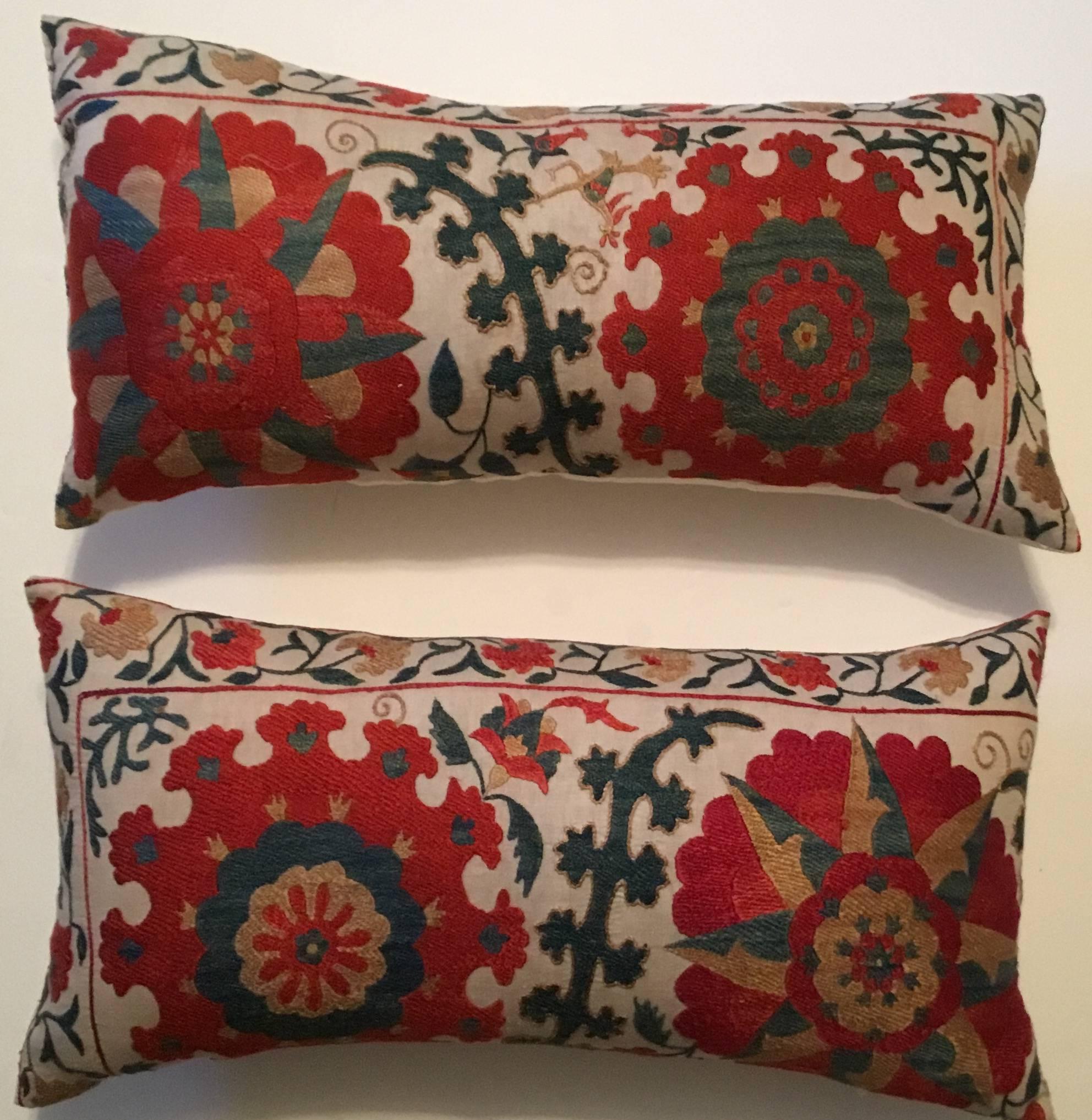 Colorful pair of pillows made of hand embroidery silk on cream color background, with flowers and vines motif.
Fresh inserts, silk backing.