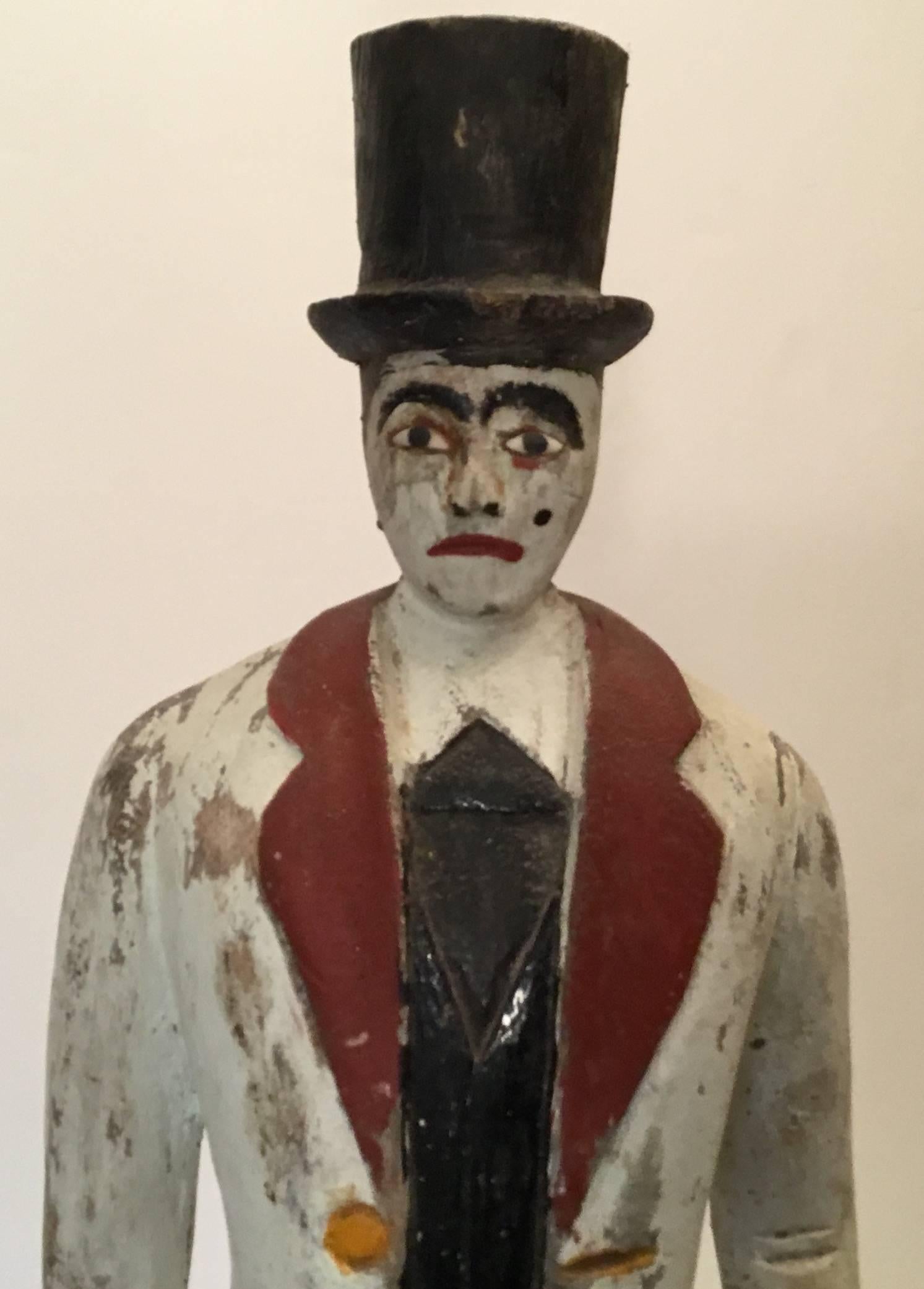 One of a kind wooden carnival Barker made of wood and hand painted, very 
expressive facial features, dapper top hat and tail. Classic piece of Americana.
Post on a wooden base.

As info, a Barker is a person who attempts to attract patrons to