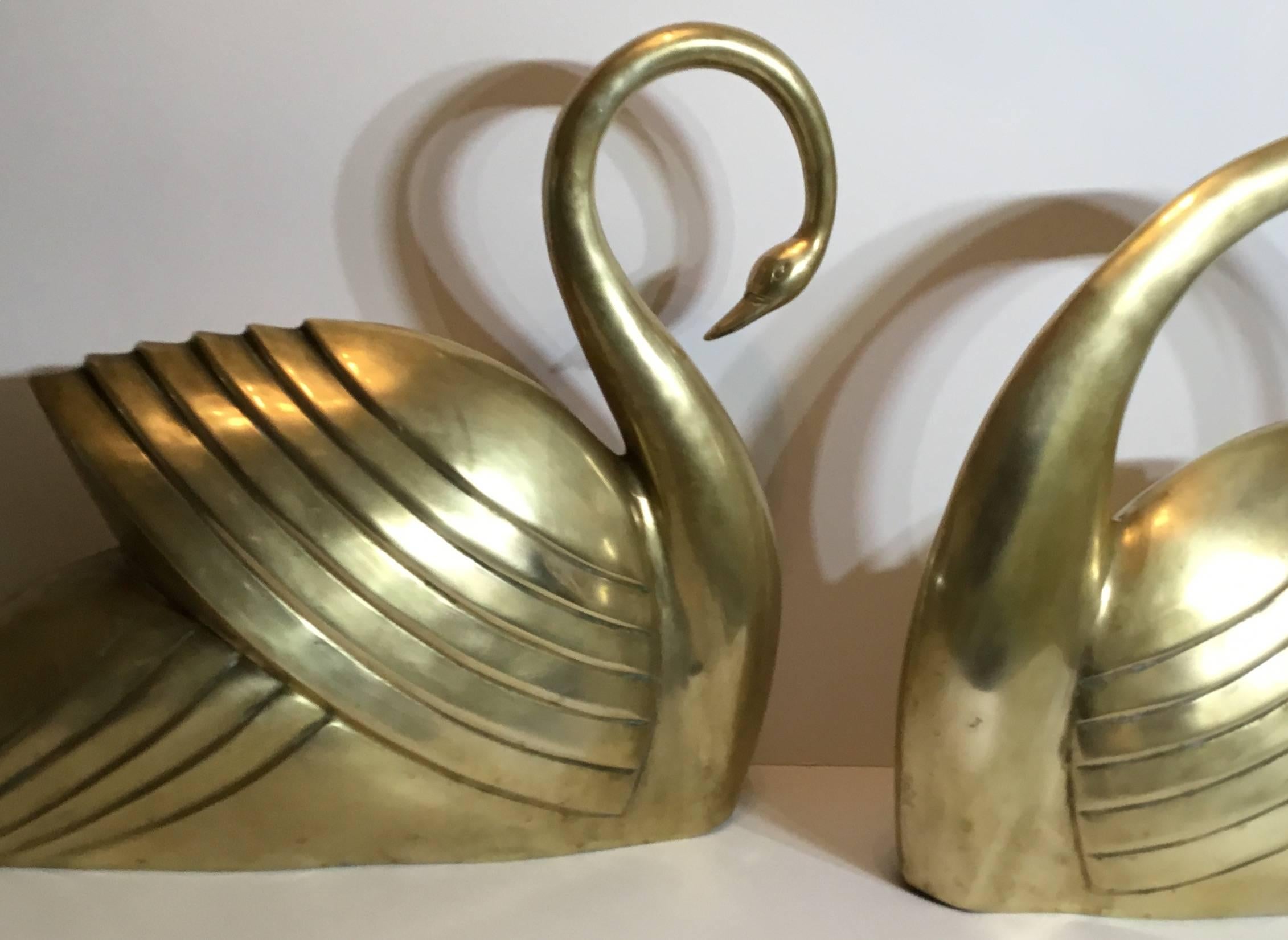 Pair of beautiful swan made of brass, gracefully tilted there heads toward each
other.

