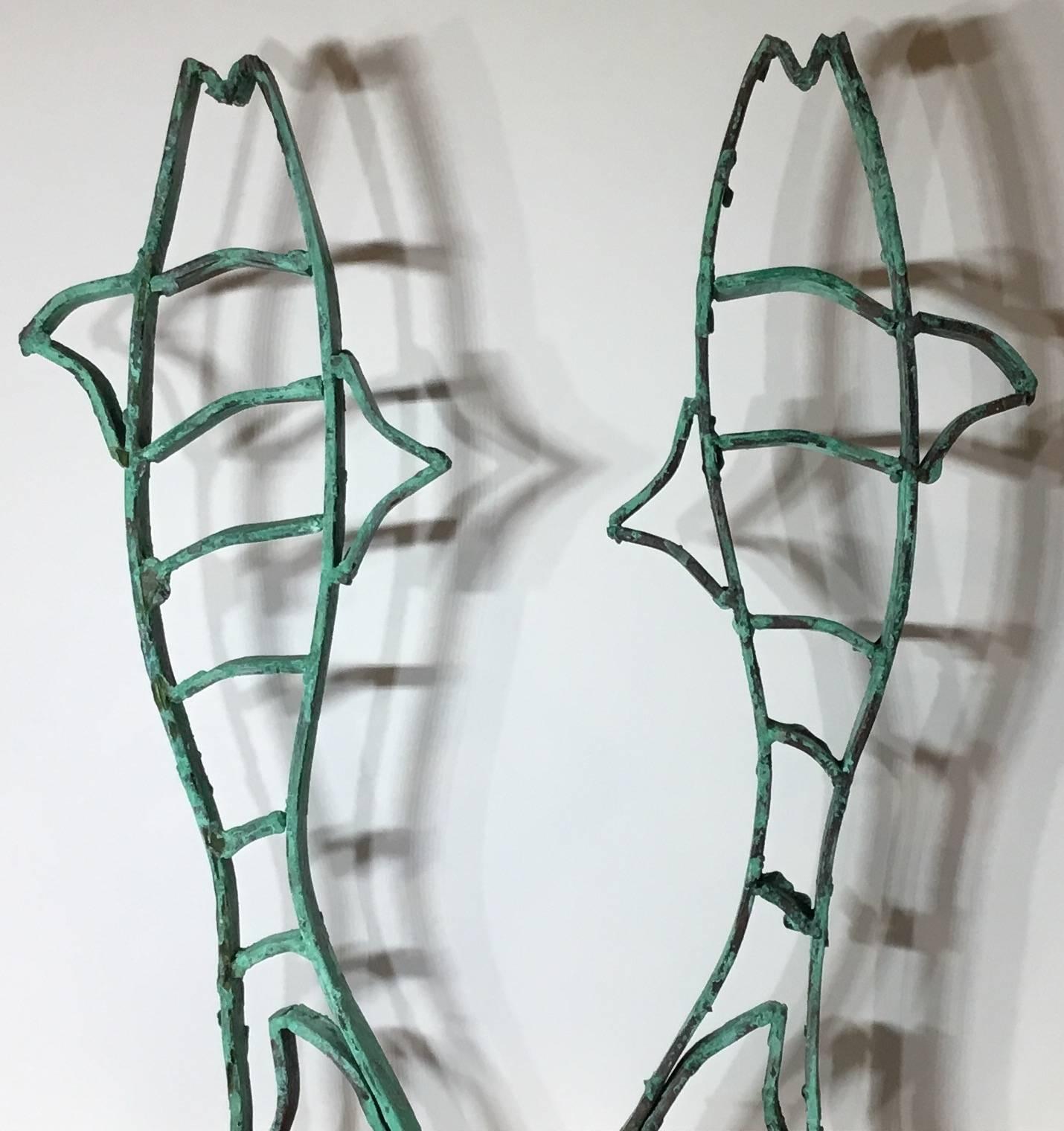 One of a kind pair of fish sculpture made of copper beautifully weathered oxidized, professionally mounted on a steel base painted in black.
This fish sculptures were part of a gate in palm beach estate in the 1920s
We acquire the salvaged gate