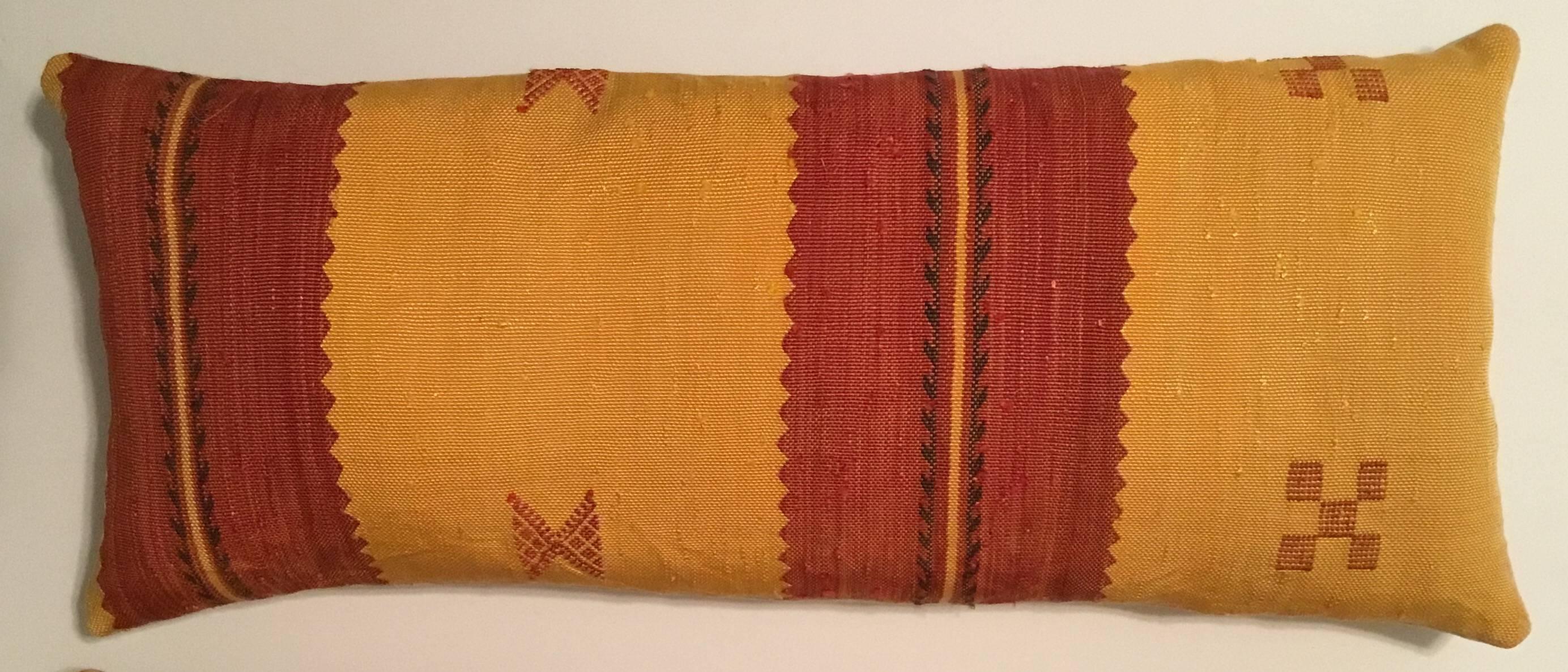 Beautiful pair of pillows made of handwoven flat-weave Kilim rug fragment.
With geometric motifs. Red-salmon and yellow-muster colors.
Down and feather inserts, silk backing.