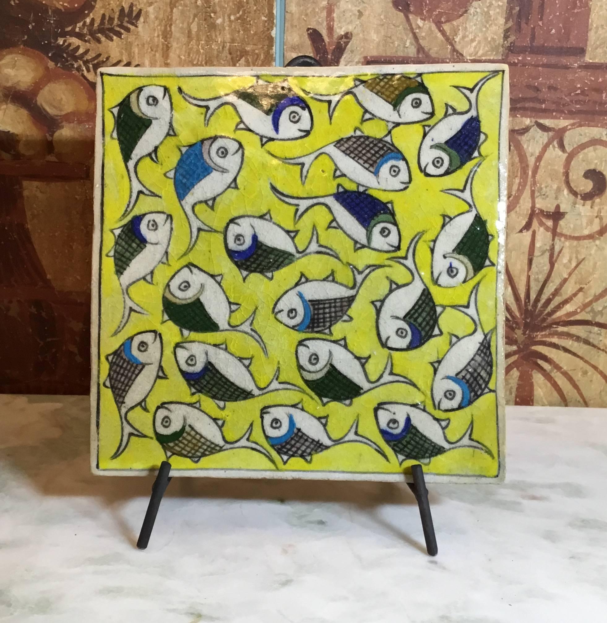 Exceptional Persian tile all hand-painted and glazed with wondering school of fish on a beautiful yellow background.
Great decorative tile display.
Functional steel display included.