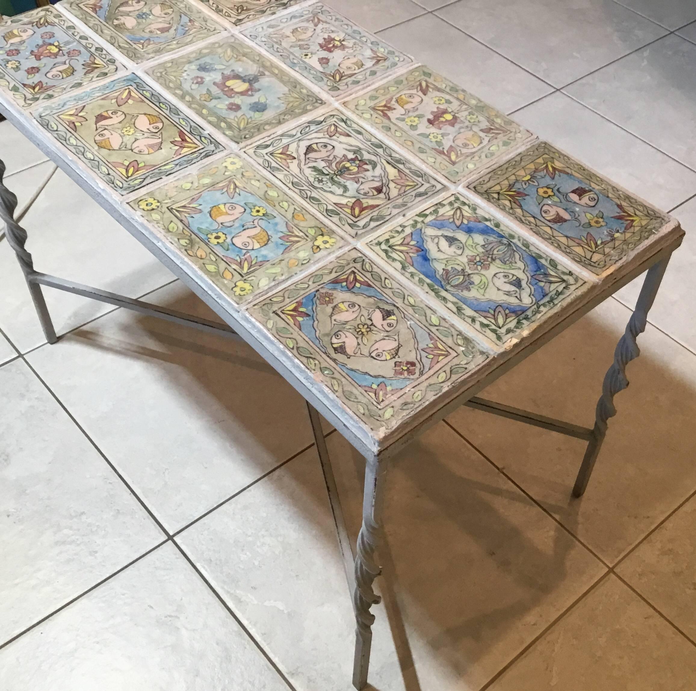 One of a kind coffee table made of iron with Hand twisted legs, professionally embedded with twelve old hand-painted Persian tiles.
Soft colors of flowers vines and fish motif and plenty to talk about this beautiful
Table.