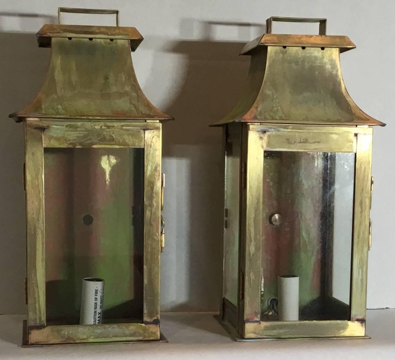 Elegant pair of wall hanging lantern made of brass, with one 60/watt light each.
Suitable for wet locations
UL approved, up to US code very good quality lanterns, made in the USA.