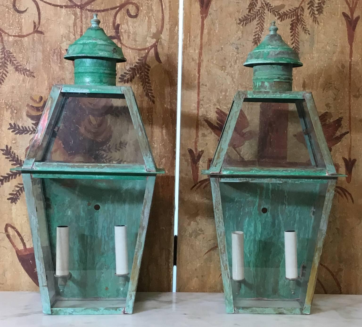Elagent pair of wall lanterns made of copper beautifully weathered, with two 
60/watt lights each electrified and ready to light.
Up to US code UL approved, suitable for wet locations, made in the USA.
