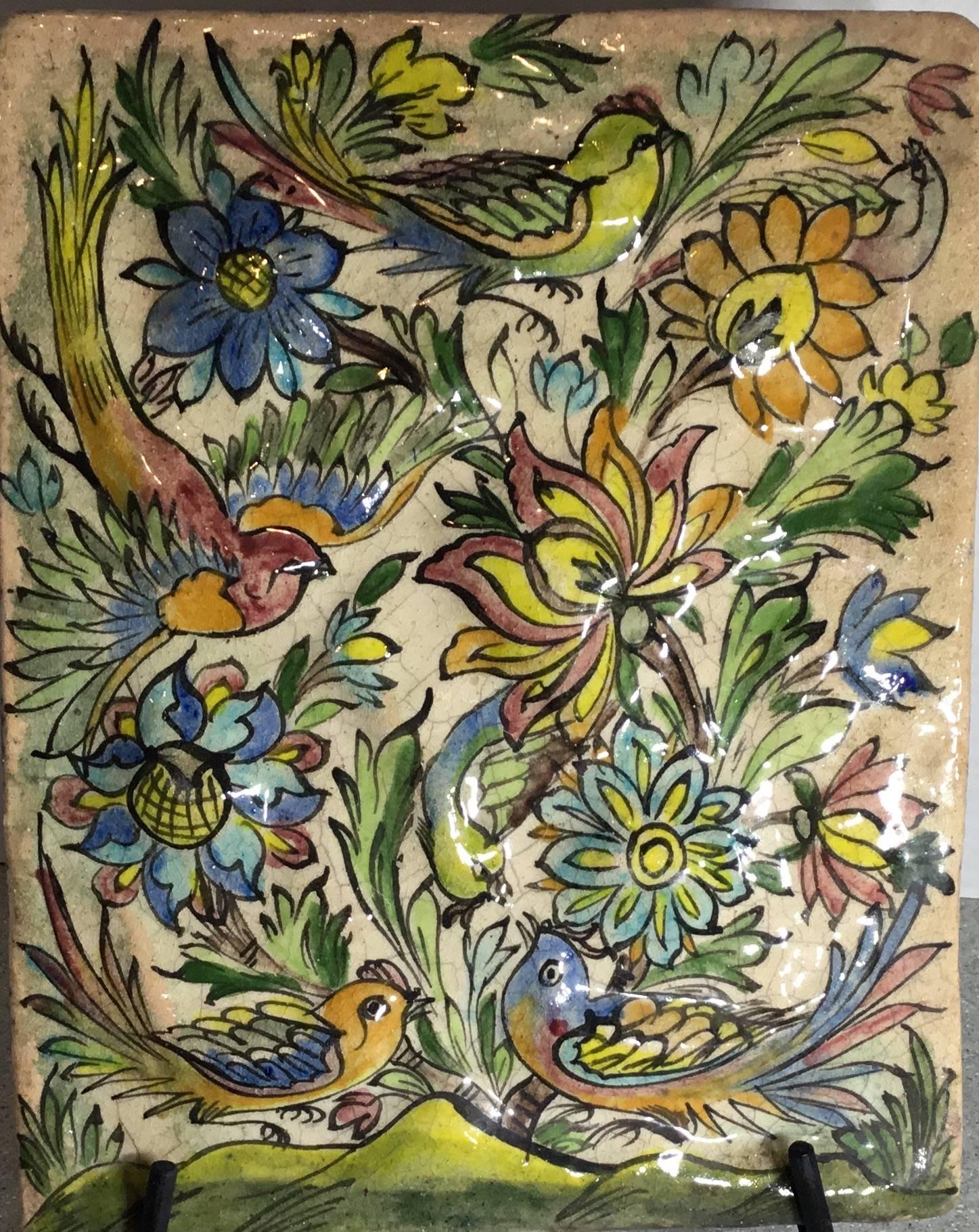 Exceptional Persian tile all hand-painted and glazed with beautiful scenery of birds flying between colorful vines and flowers on a cream color background.
Great decorative tile on display.
Functional steel display piece included.
     