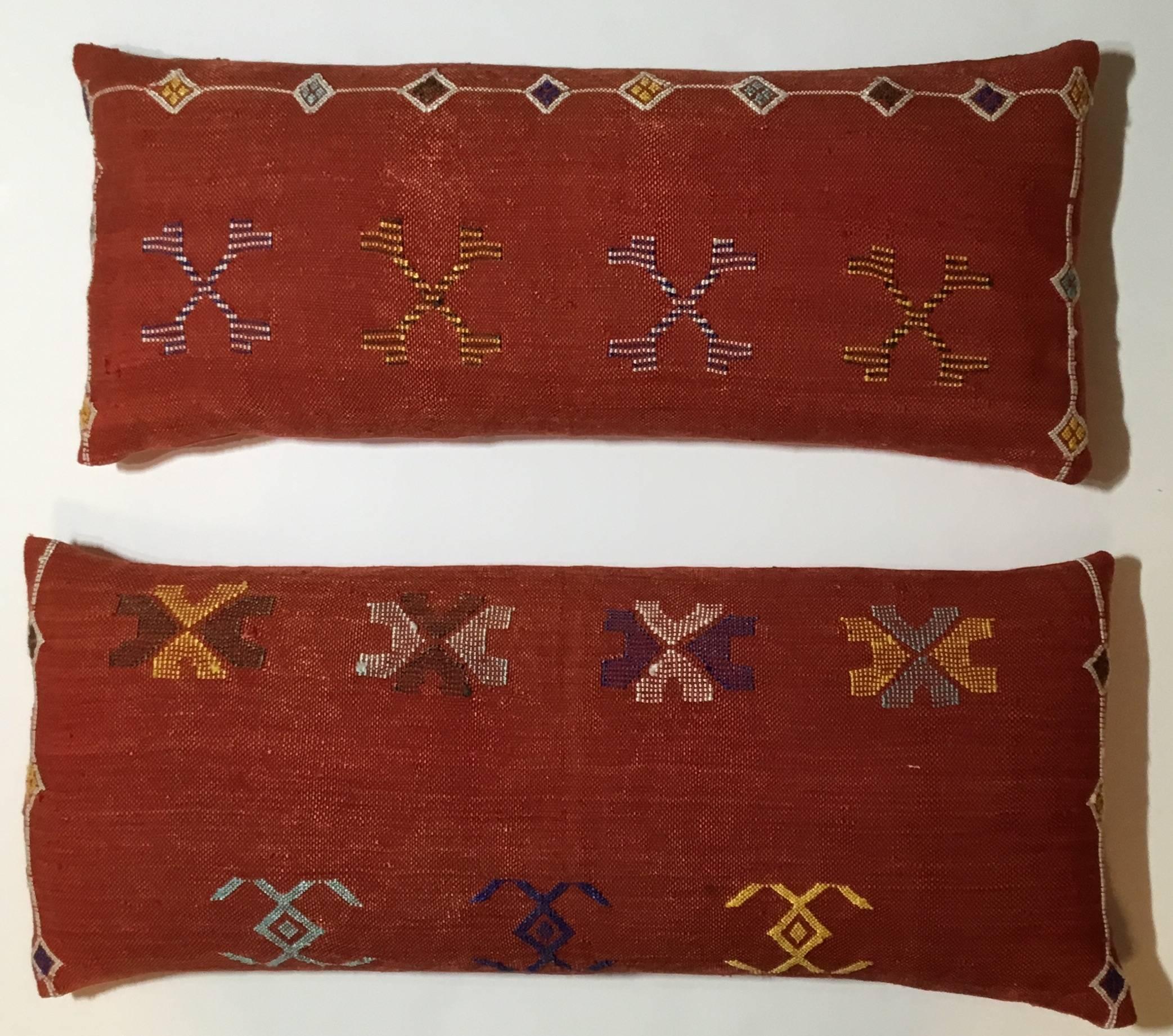 Beautiful pair of pillows made o of handwoven flat-weave Kilim rug fregment.
With colorful geometric motifs on a red -salmon color background.
Silk backing, Frash down and feather inserts.
Measures: Size one 11" x 27"
Size two 12"