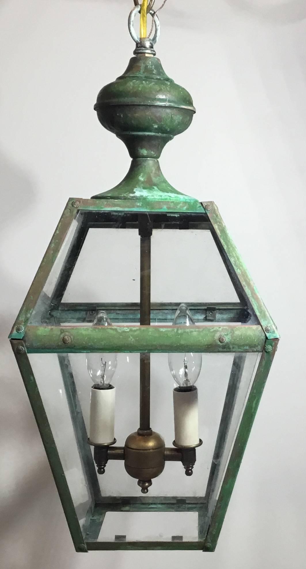 Elegant hanging lantern made of brass with newly brass cluster of two 60 watt lights, suitable for wet locations, fine copper canopy included. Measures: 8