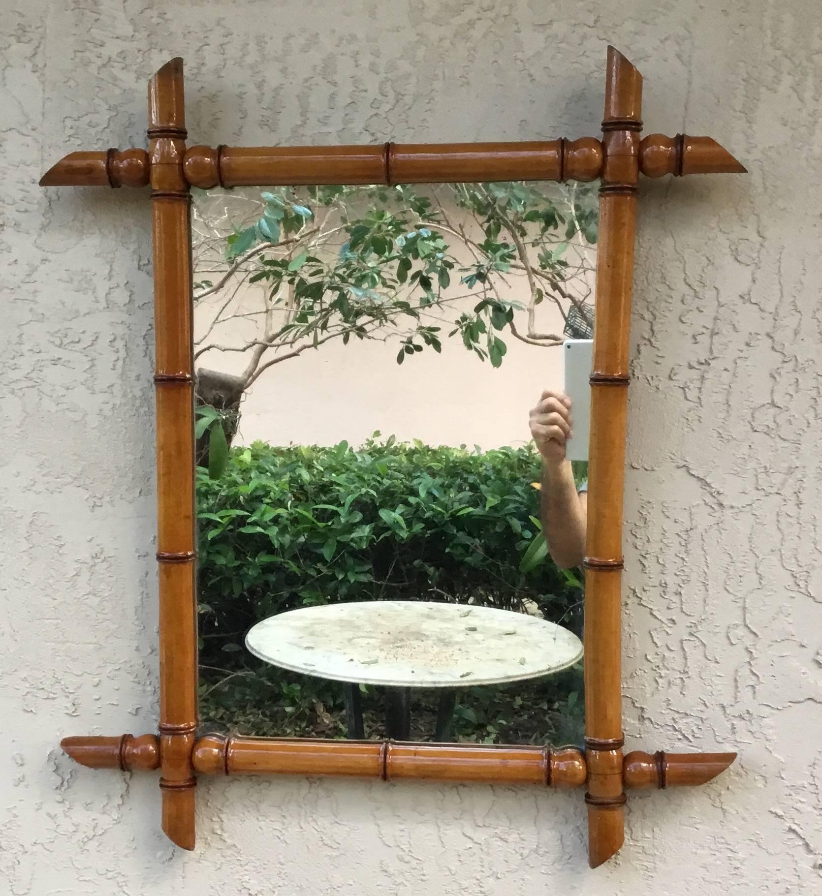 Elegant bamboo mirror that retains the beautiful old patination, with some age distress in the glass mirror, wood backing.