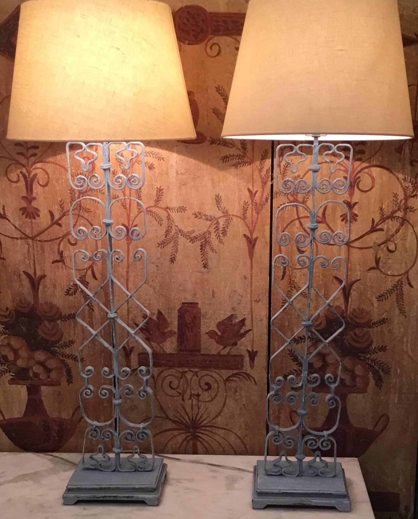 Pair of architectural table lamps made of antique hand-forged iron professionally mounted on a decorative wood made, newly electrified and ready to use.
Total height is without the shades 36