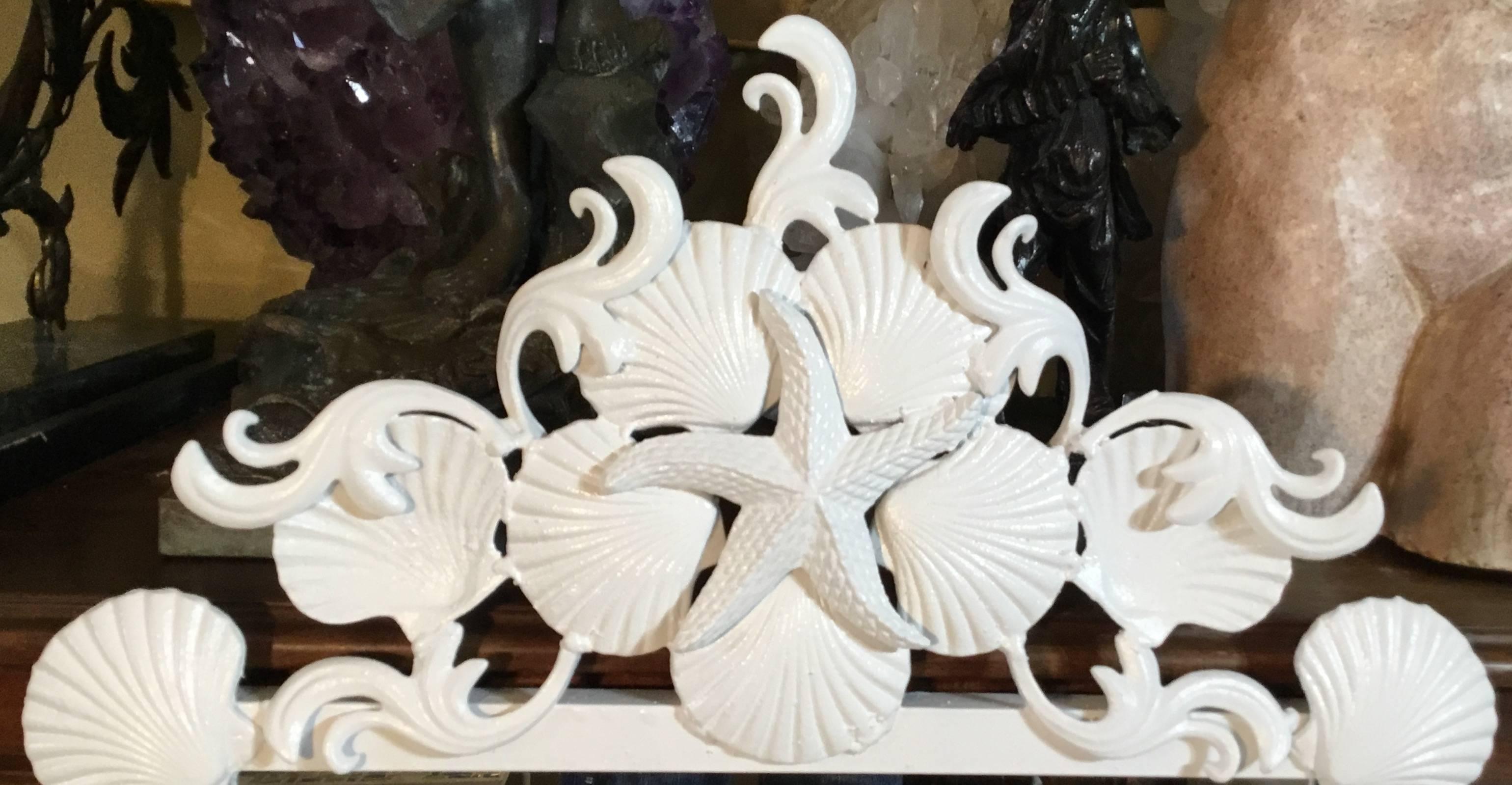 Pair of mirror made of iron, artistically decorated with sea shell and sea star motifs, painted in white.
Will sell single mirror upon request.