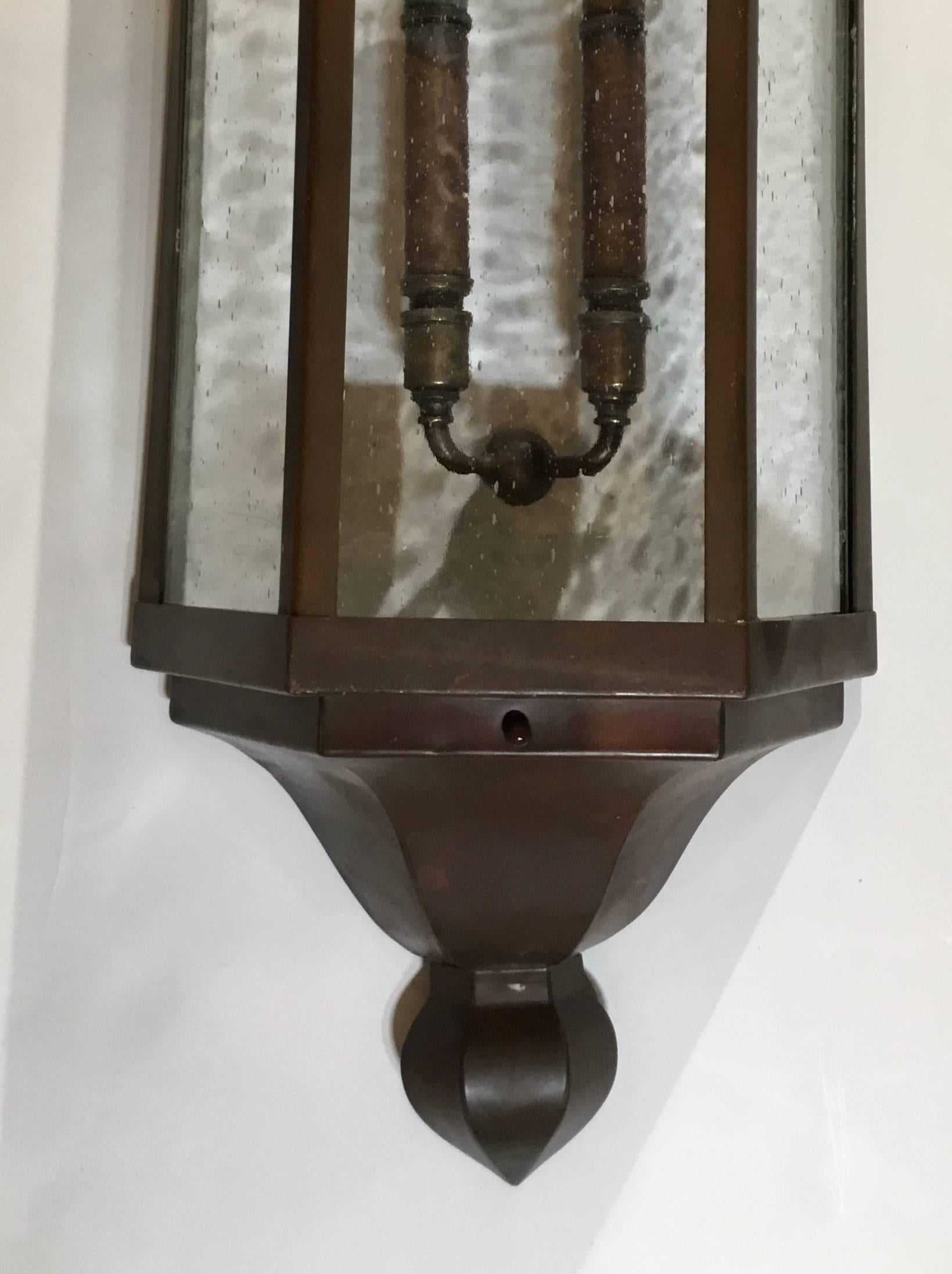 Rescued from a 1930s Art Deco building this large pair of sconces made of copper with seeded glass was restored with custom made steel backplate, treated for rust with one new brass cluster of two 60/watt lights all ready to use. Great pair of