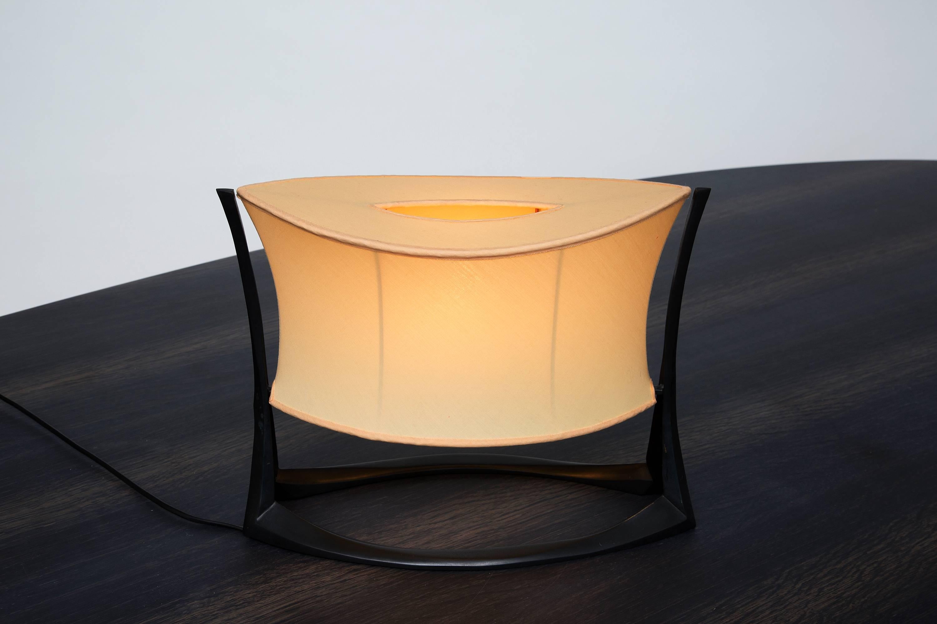 Elegant bronze lamp by Anasthasia Millot. Millot originally studied fashion design in Paris, and her work with fabric has left a lasting -- if indirect -- influence on her objects. After years of painstaking experiments, Millot has learned to