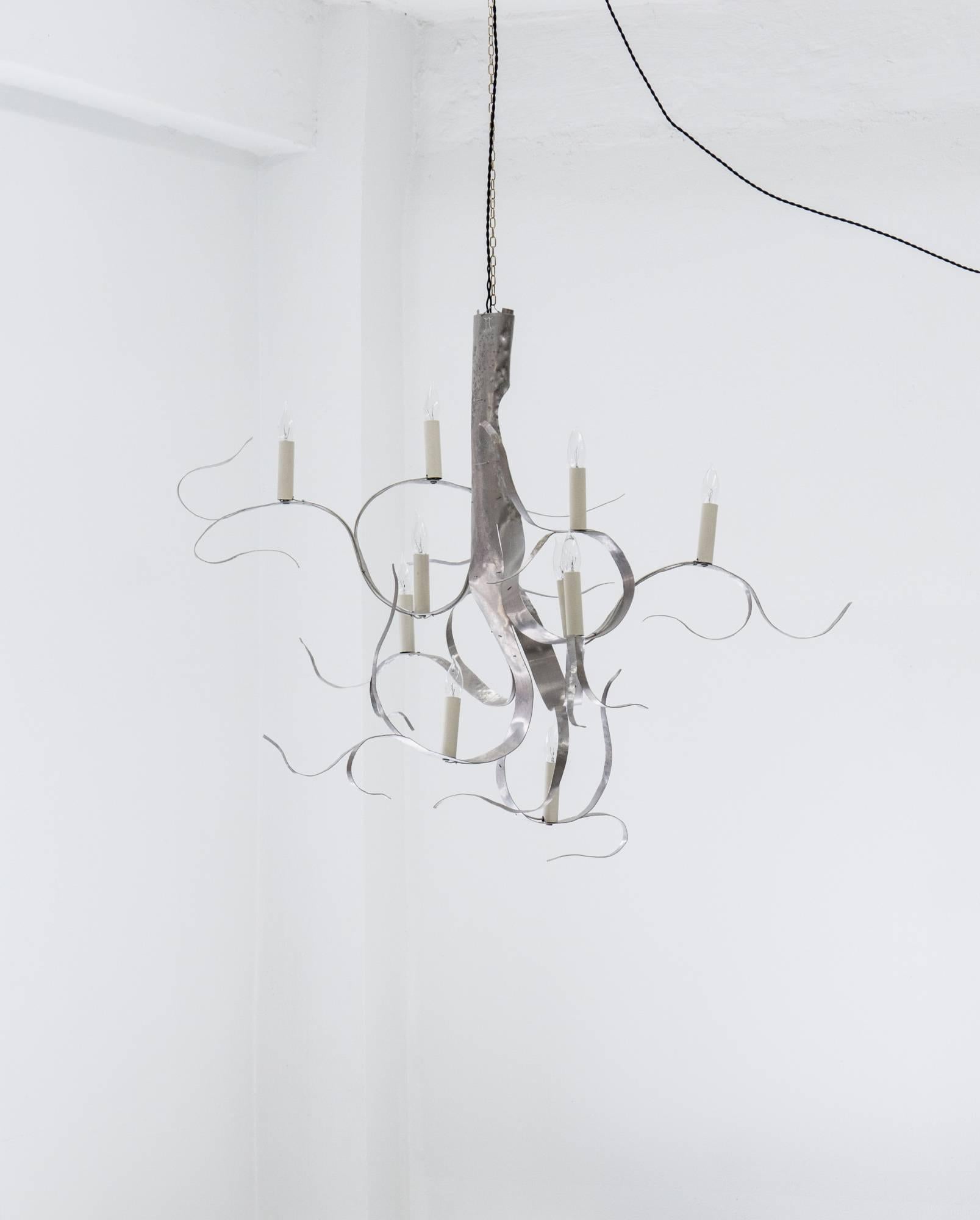 Inspired by Karl Blossfeldt’s photographs of flora, this 10-light chandelier is cut from one sheet of aluminum, then twisted and hammered by hand without discarding any of the material. The work seems to be in movement, as if it were growing like