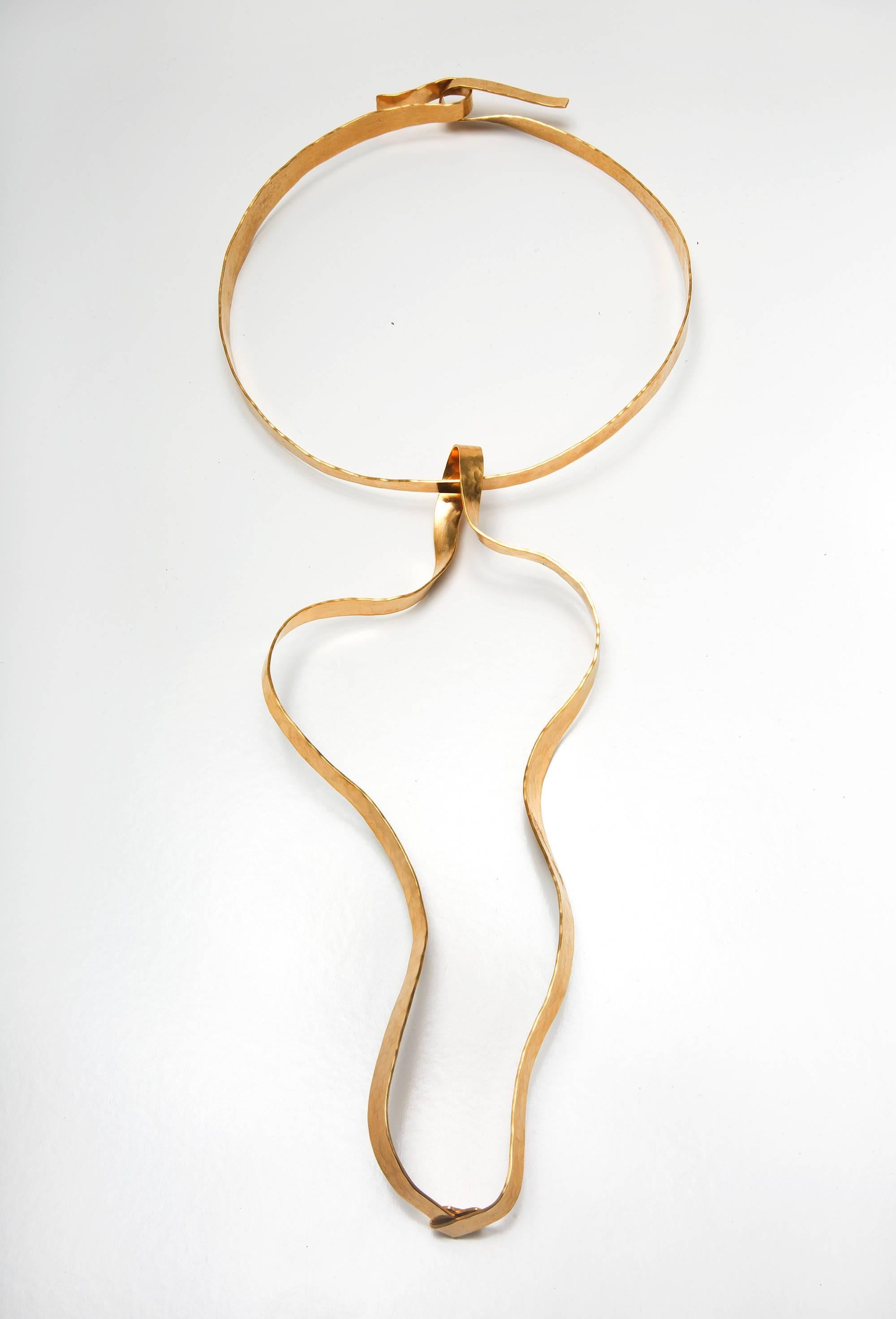 From his first collection of jewelry: A large pendant necklace in gold-plated brass, hand-hammered by Jacques Jarrige
Jarrige's jewelry is more companion than ornament, heightening one's physical awareness and bestowing the pleasure of inhabiting a