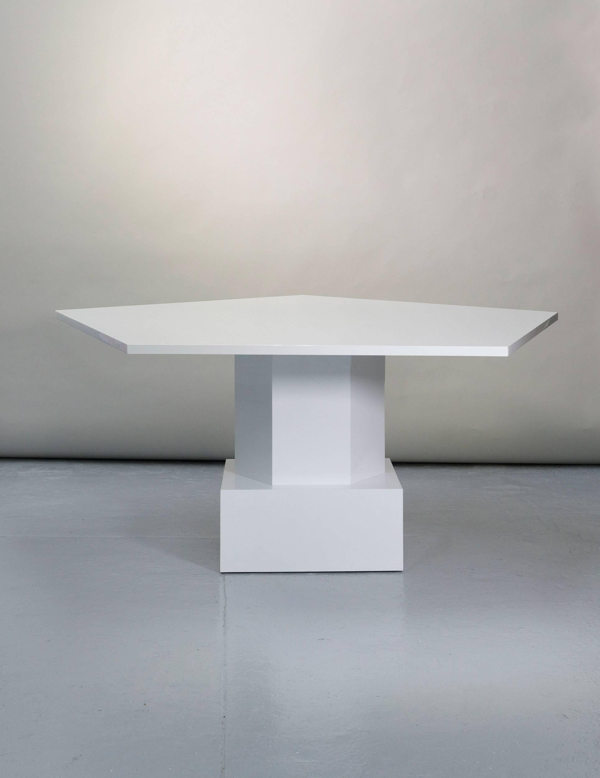 A stunning dining table by Tinatin Kilaberidze who finds inspiration in geometric forms. The designer chose a white lacquer for this pentagonal shaped dining or centre table that can be used alone or paired with another in walnut to seat over ten