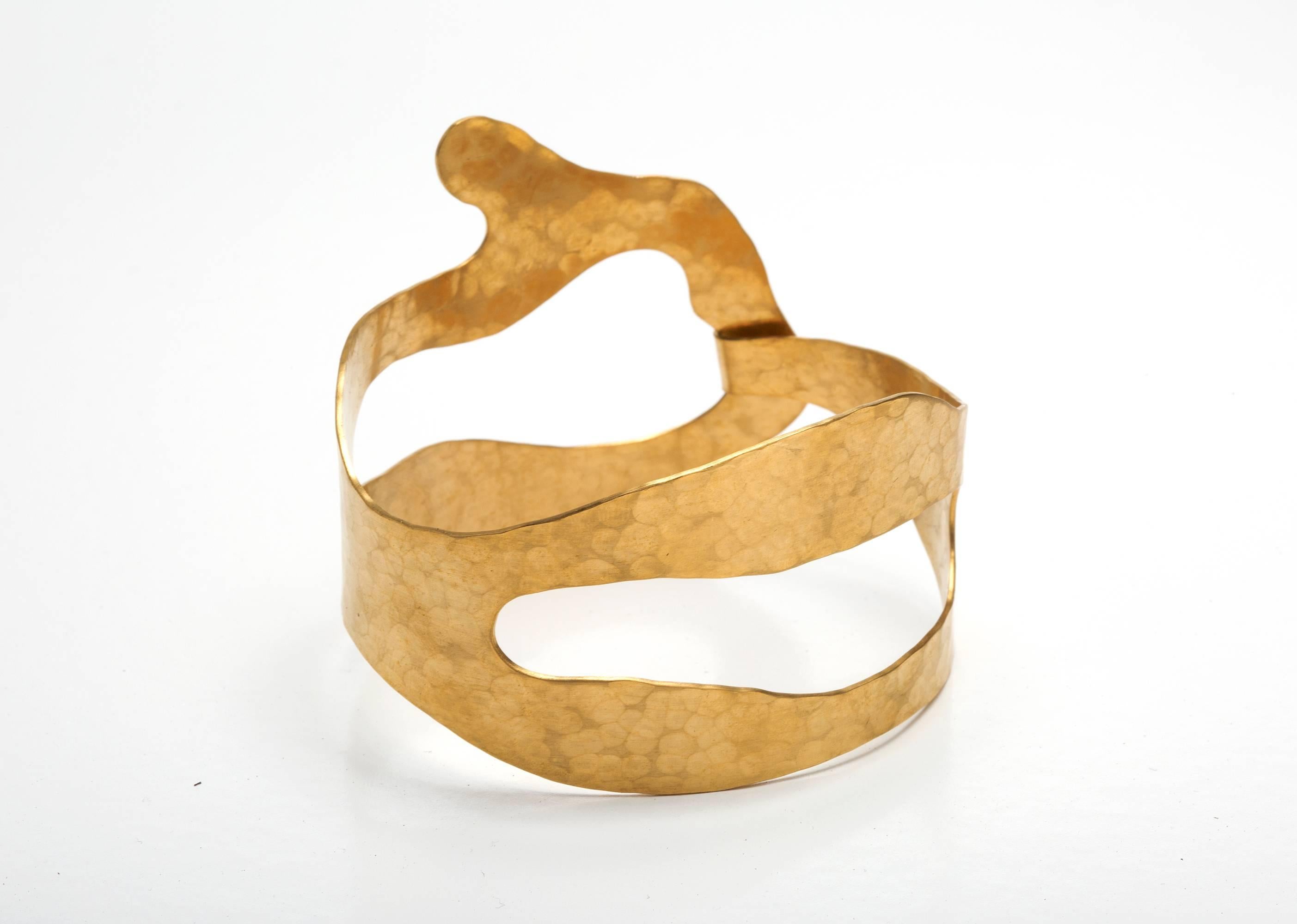 Gold-plated brass and hand-hammered Bracelet by Jacques Jarrige.

Jarrige's jewelry is more companion than ornament, heightening one's physical awareness and bestowing the pleasure of inhabiting a well-built structure — a structure so light that