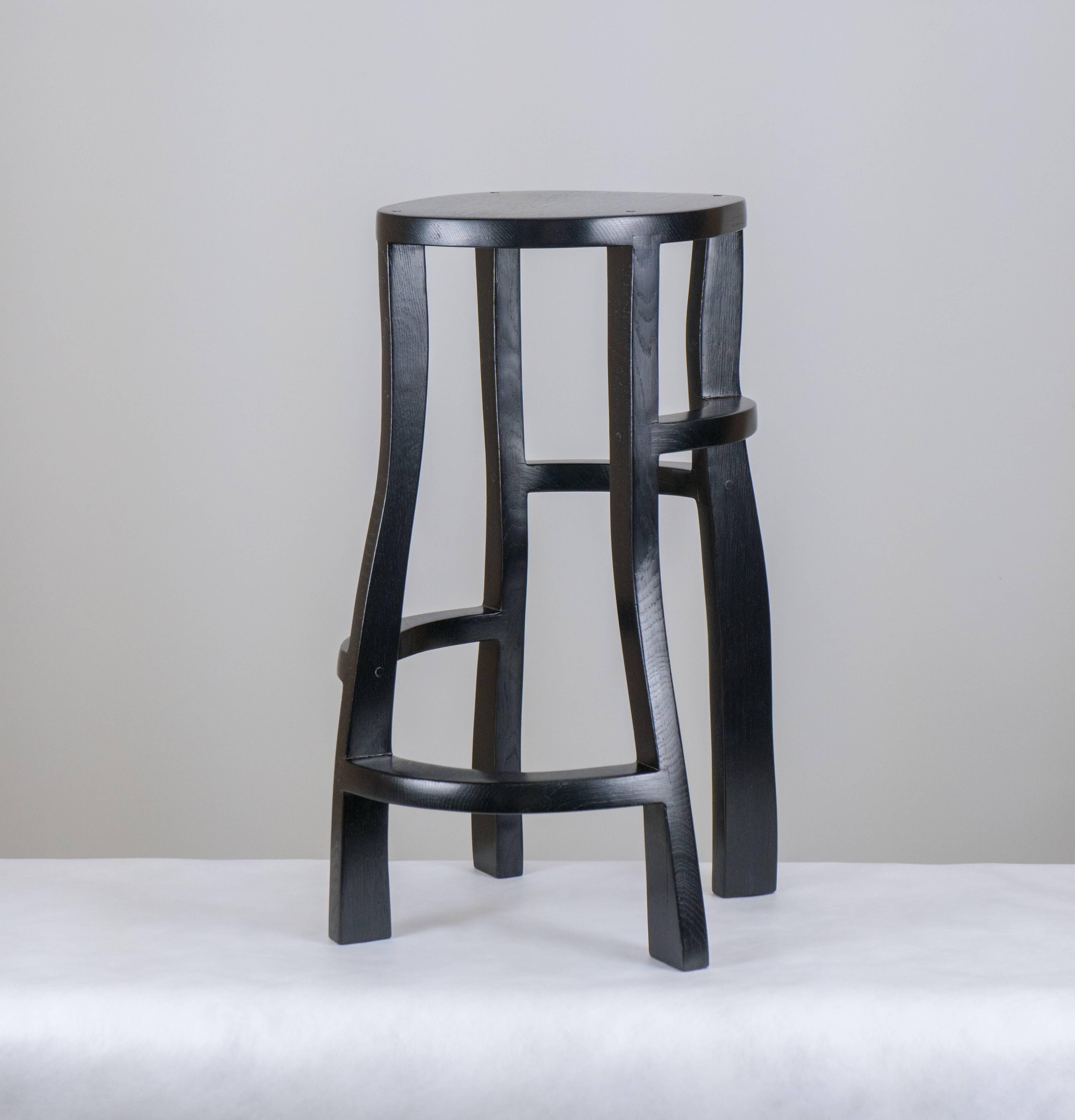 Sculpted bar stools in stained oak by Jacques Jarrige. Sculpture as much as functional stool this piece, arrested in movement, always remains captivating from every angle.

Jacques Jarrige was born into a Parisian family of art collectors and