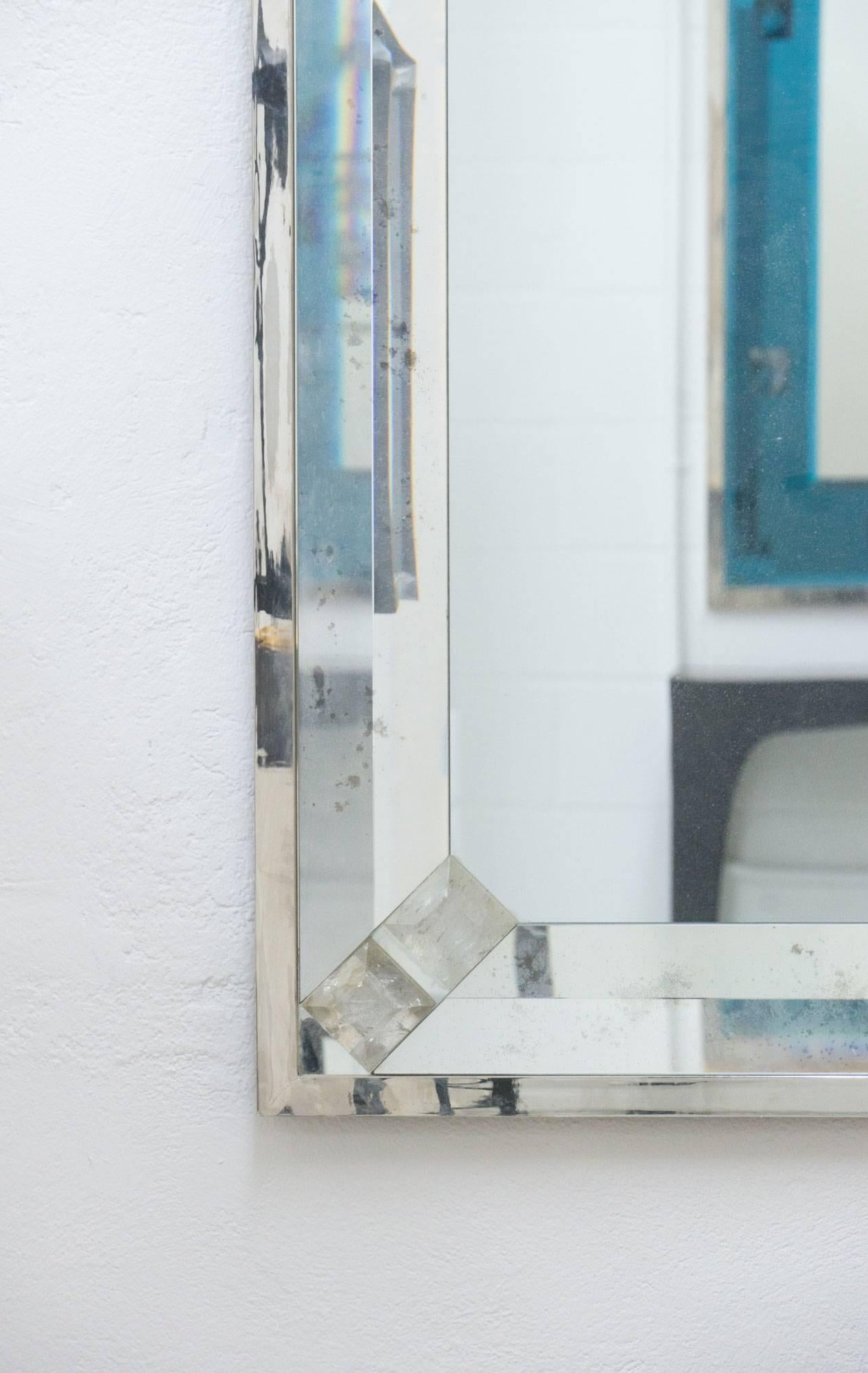 An elegant mirror by contemporary designer Andre Hayat. 

The mirror is set in beveled antique glass and rock crystal on each corner. The frame is in nickeled brass.