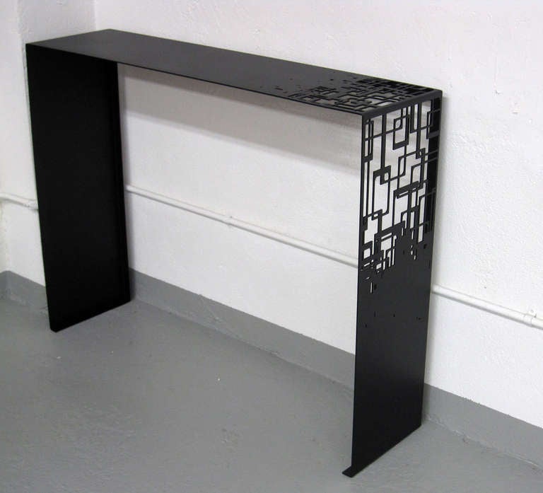 An elegant modern console table finished with black epoxy paint.
Pair available