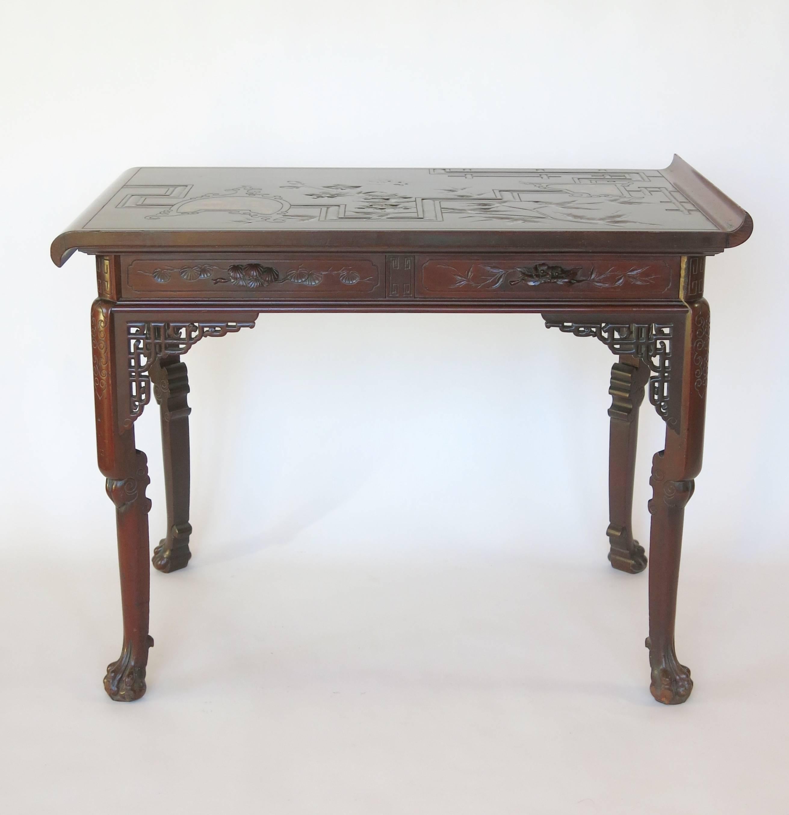 This fine and rare French centre table by Gabriel Viardot is made of rosewood with mother-of-pearl inlay, all in the Japonisme taste that was so popular in Paris in the late 19th century. The top, with up curved and down curved ends is carved with