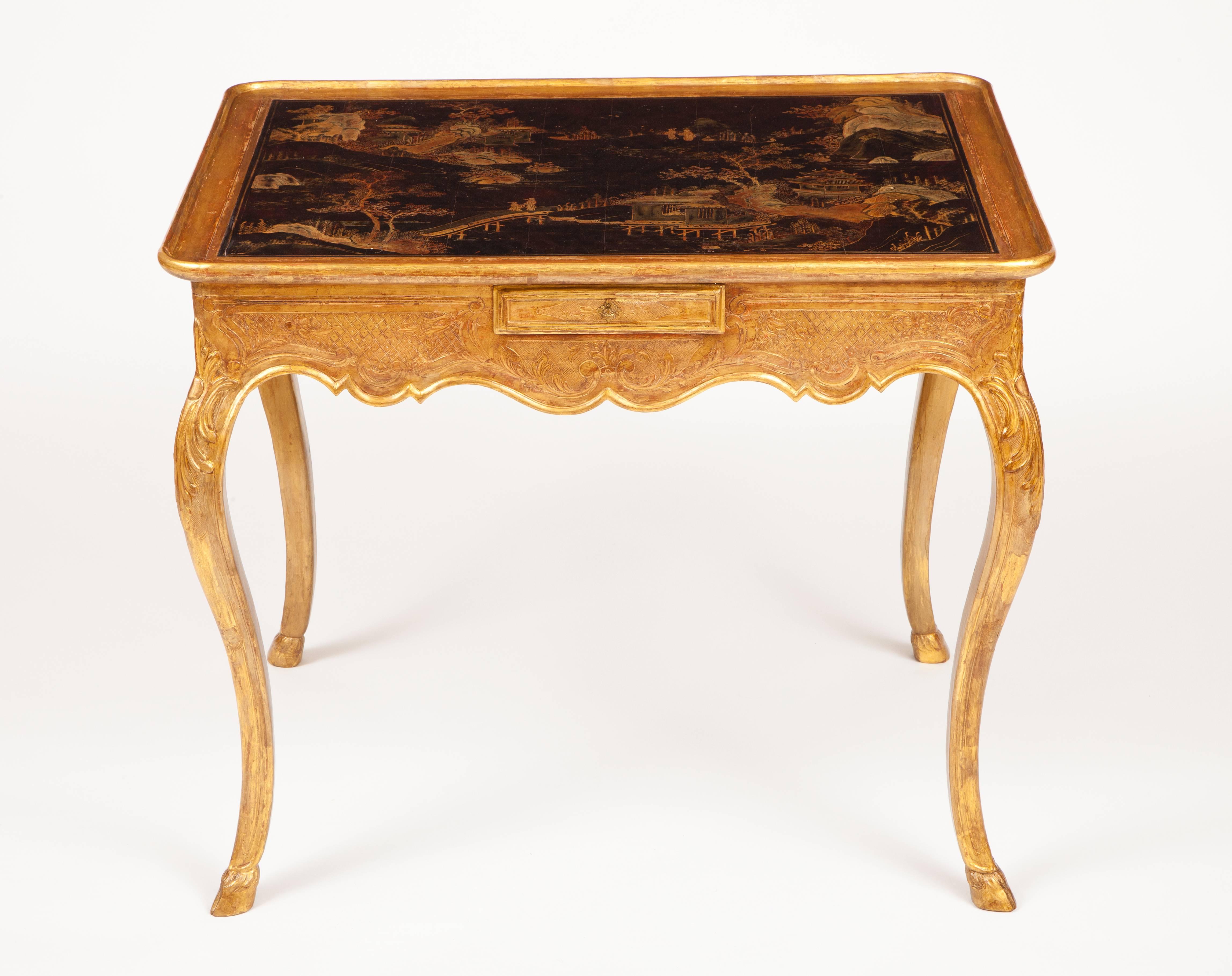 This very fine French early Louis XV period table with its lacquered tray-form top with chinoiserie scenes above carved and gilded base with cabriole legs ending in hoof feet, is described as a table en cabaret, used in the period to serve coffee