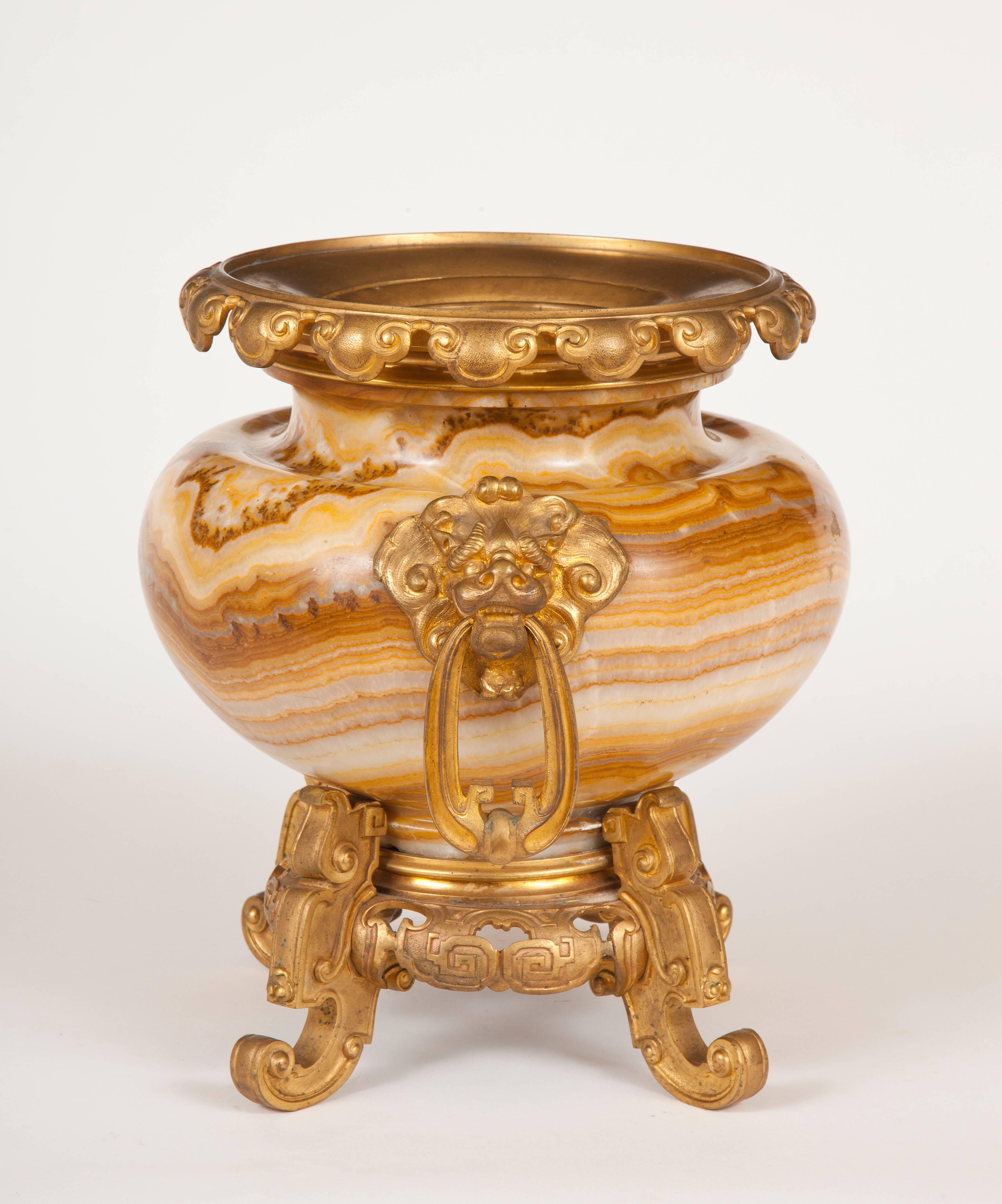 An excellent example of the Napoleon III for Asian exoticism, this fine French urn is made of banded alabaster with gilded bronze mounts all in the taste for Japonisme.