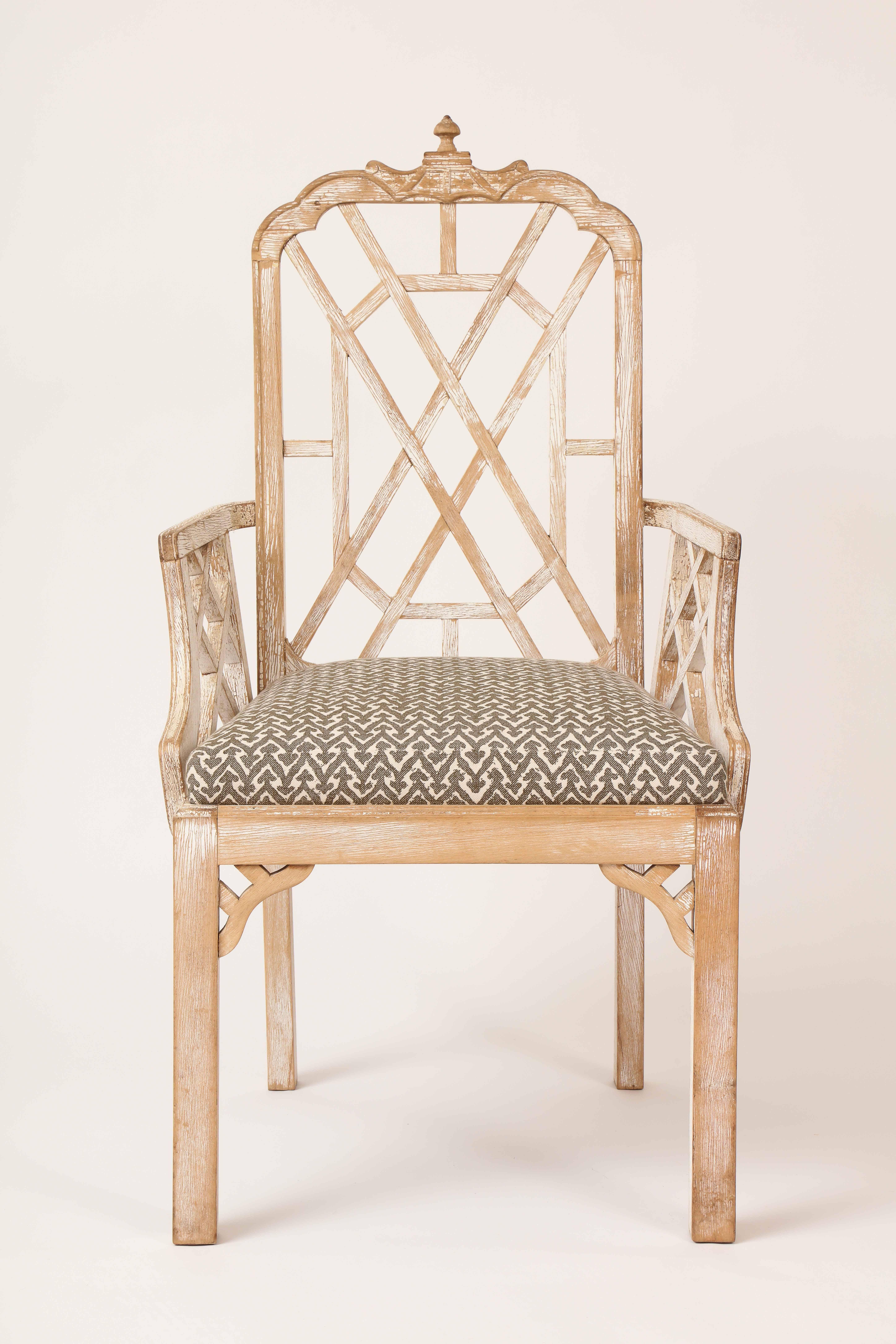 This English Georgian style armchair in the Chinese Chippendale taste, made of wood with original distressed paint, has a lattice form back, with armrests raised on matching lattice, raised on block form legs.