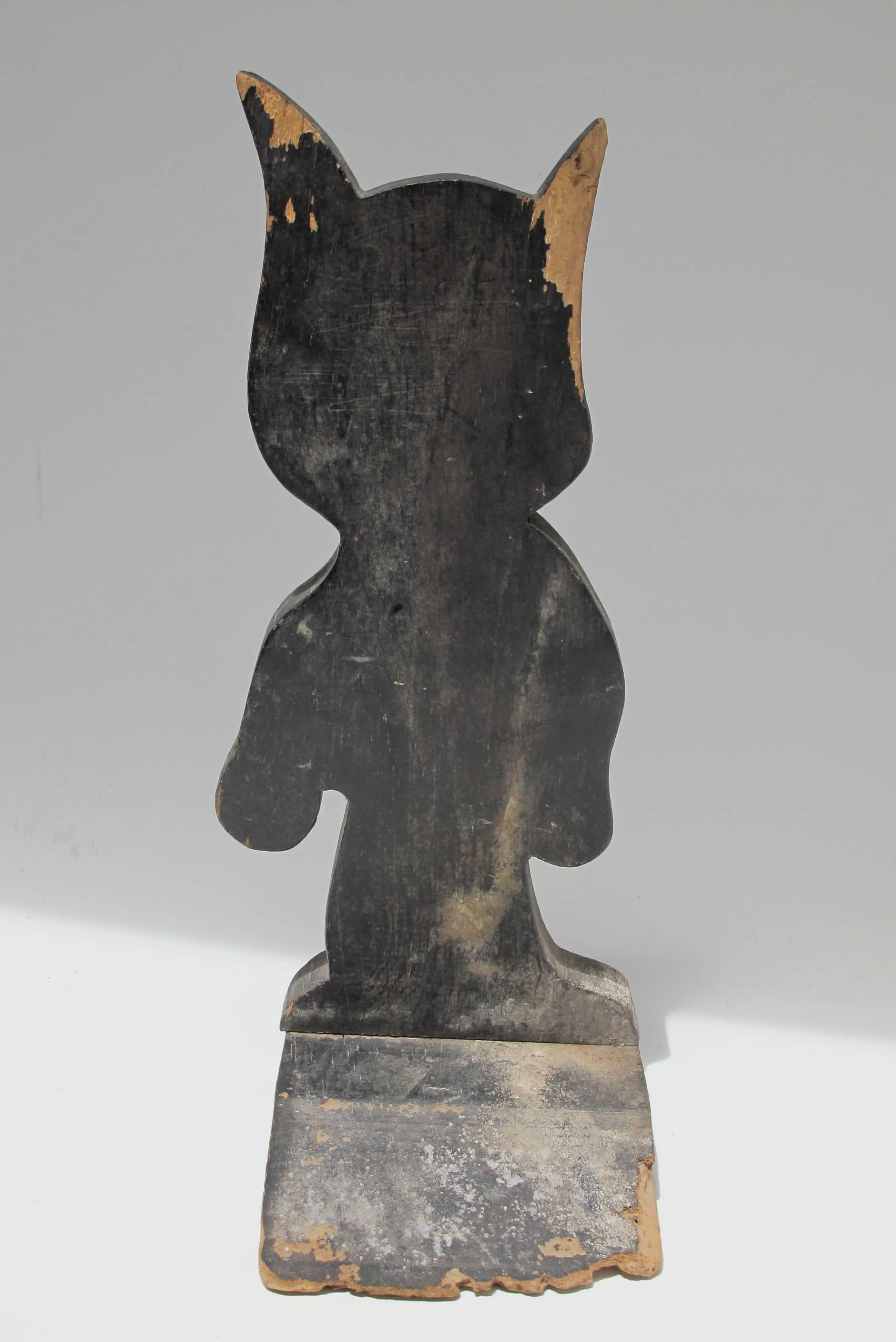Cut and painted wood image of the great cartoon character Felix the Cat, a wood wedge is fixed the back of Felix to slide under a door to keep it open.
Felix the Cat became enormously popular in the 1920s and was the first animation superstar