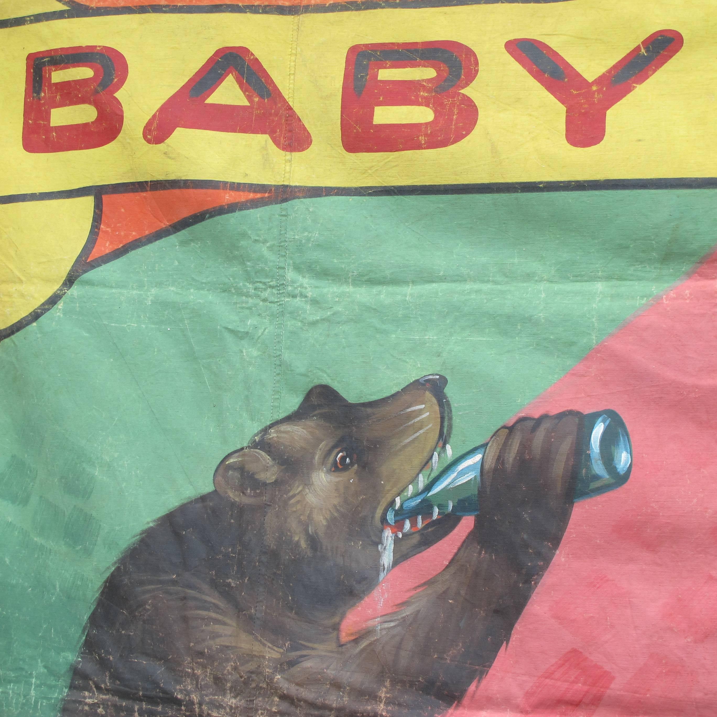 Painting on canvas tarp of baby bears drinking out of bottles. Attributed to the famous carnival sideshow painter Snap Wyatt (1905-1984). The banner has his distinctive lettering and combination of bright colors. This would look great in a bar area