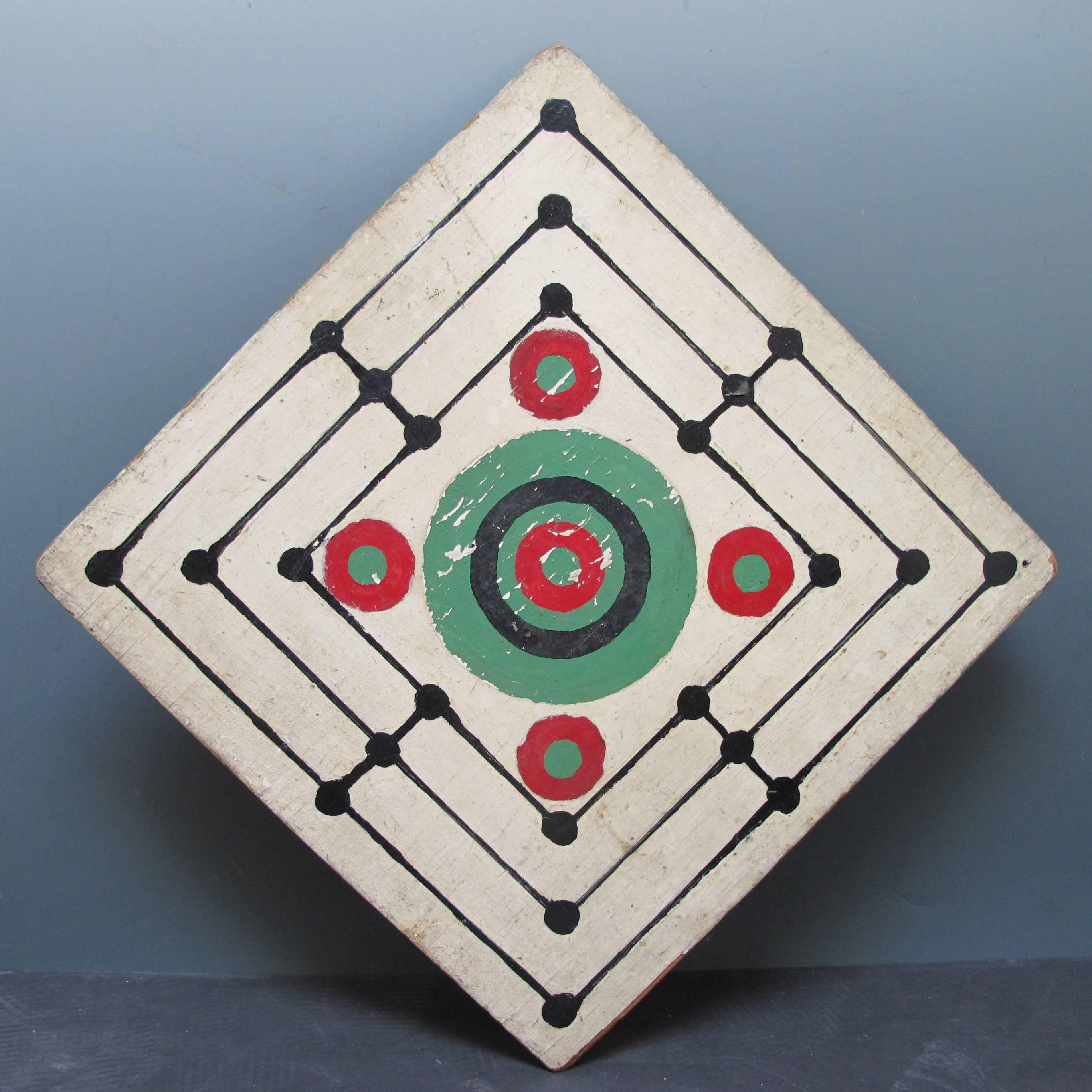 Graphic and unusual Mill gameboard with checkers on reverse. What makes this special is the original paint decoration in the center in contrast to the linear concentric squares.