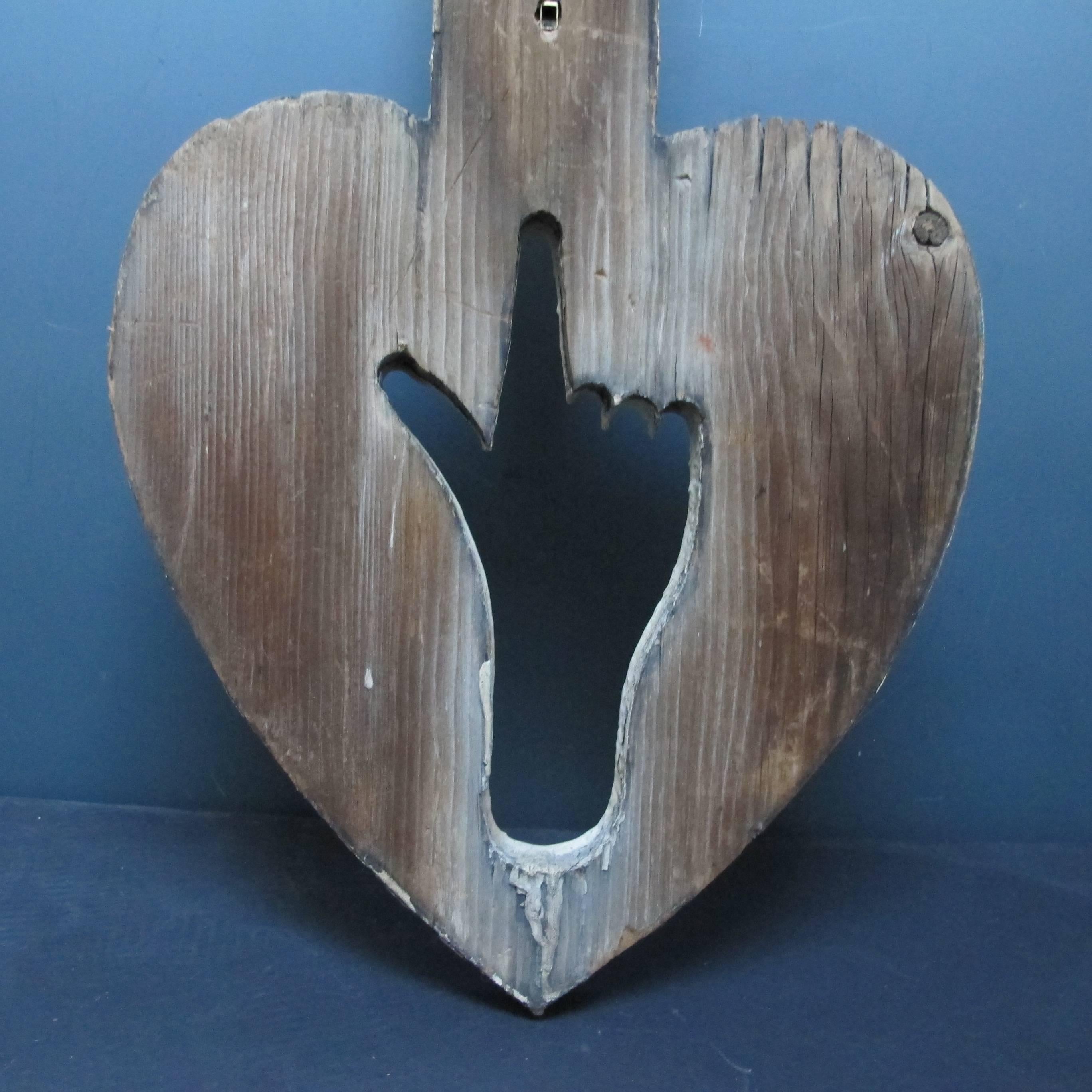 Unusual architectural piece with a cut-out pointing hand in a heart. This architectural piece hung down from the peak of a Victorian house with a form sometimes referred to as a Hand of God as it points to the heavens. Nice old paint on one side.