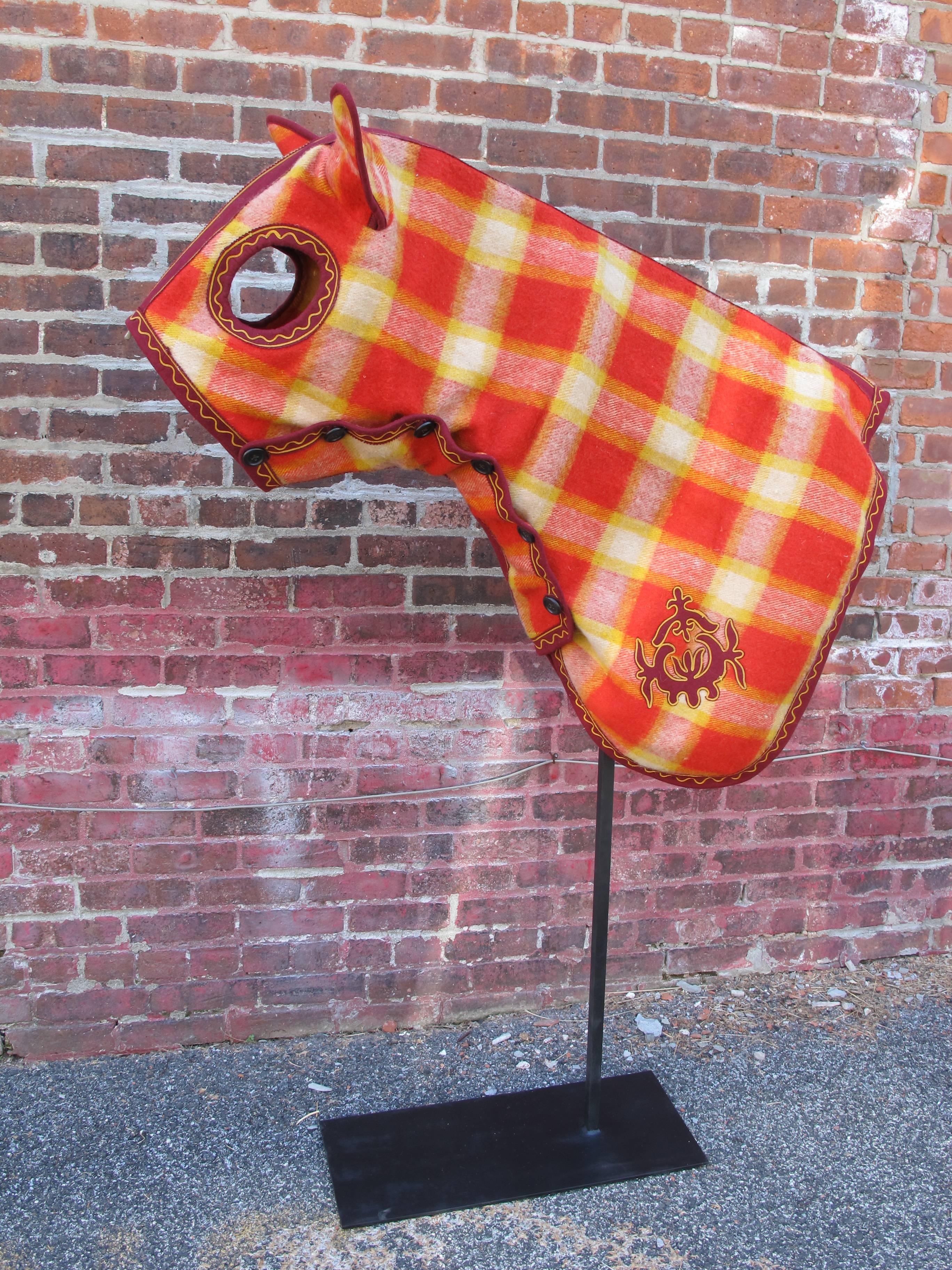 Thoroughbred and other horses can be greatly disturbed by flies. This hose cloak would have offer some protection as well as making the horse appear special. Made of checkered pattern wool with button up front it has the detailing of something