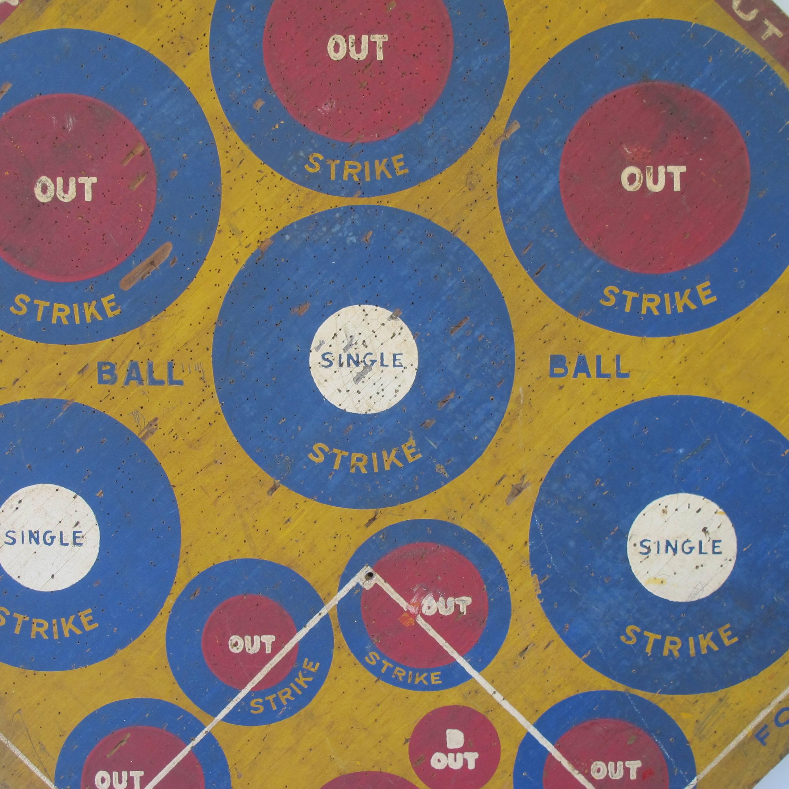 Graphic dart game board with painted circles for pitches, hits and outs. A golf game equally graphic painted on reverse side. Marked Rainshine Golf, copyrighted by E.W. Love, Joplin Mo.1932.