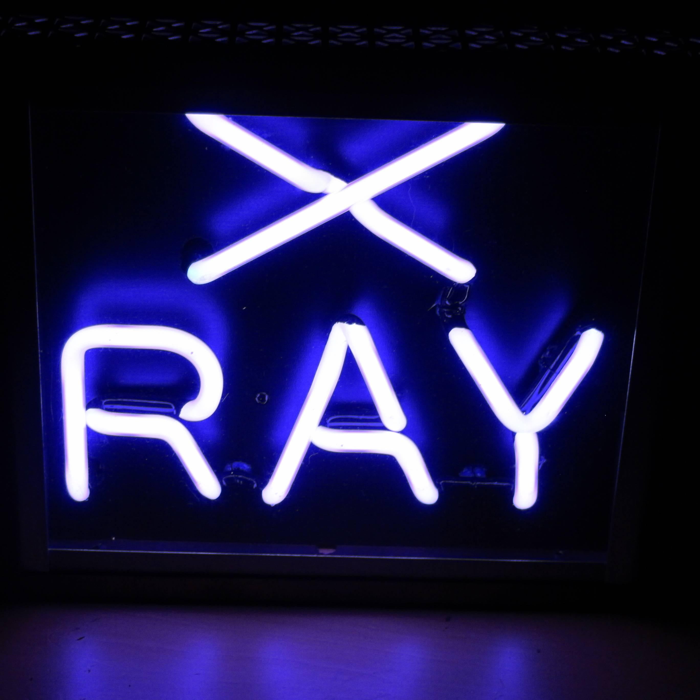 This neon X-ray sign once warned patients and doctors that they had entered an X-ray zone in a Buffalo hospital. The neon give off a deep violet color similar to what you used to see with black lights. It probably has been rewired as it has a plug