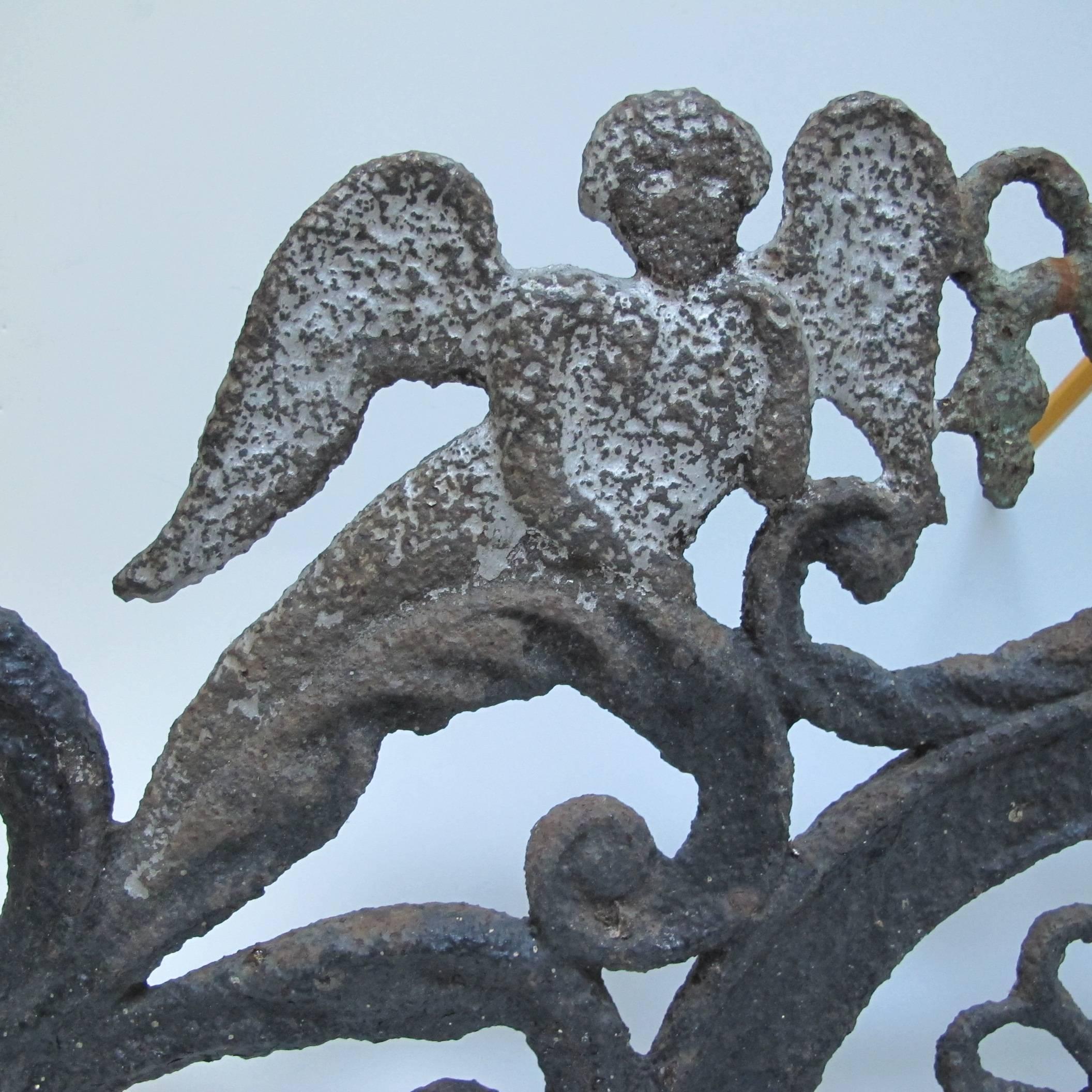 Finely made cast iron fence or gate top from the 19th century. The angels flank an urn which may have come from a relocated cemetery which happened as roads were built. Formerly from the collection of early American Folk Art of Harvey and Isobel