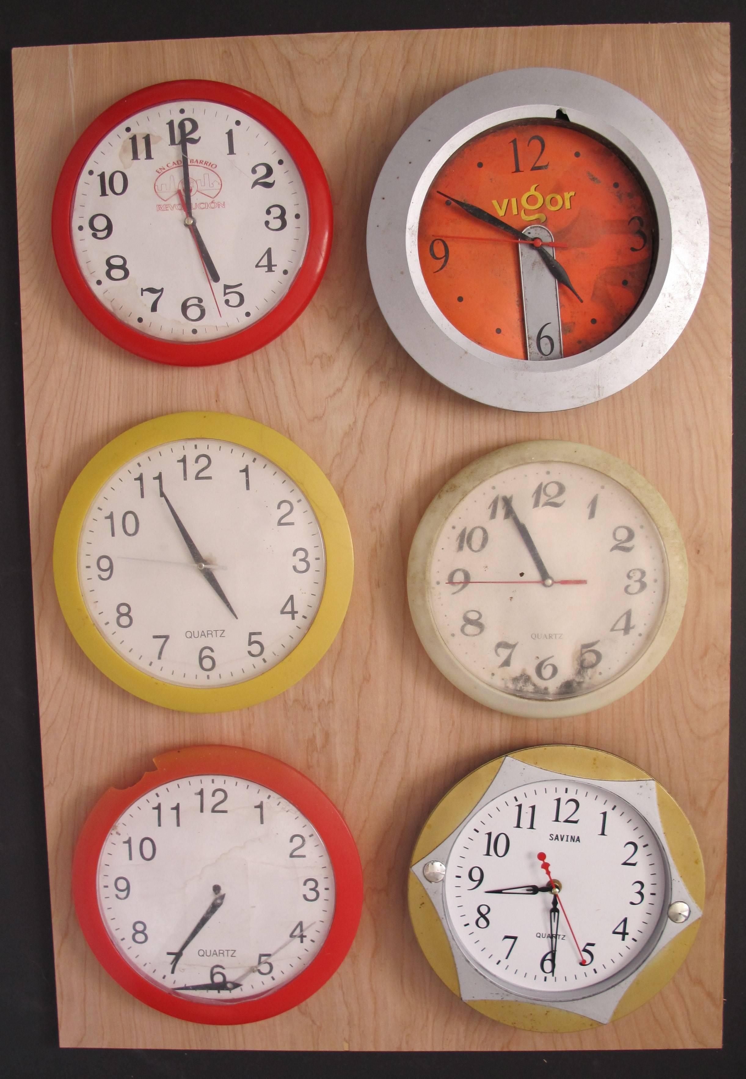 Six non functional clocks on panel by Canadian artist Kalev Jaason. In traveling in Cuba over a period of many trip Kalev noticed that in many houses there were wall clocks where time was frozen. He noted that maybe 90% of the clocks hands did not