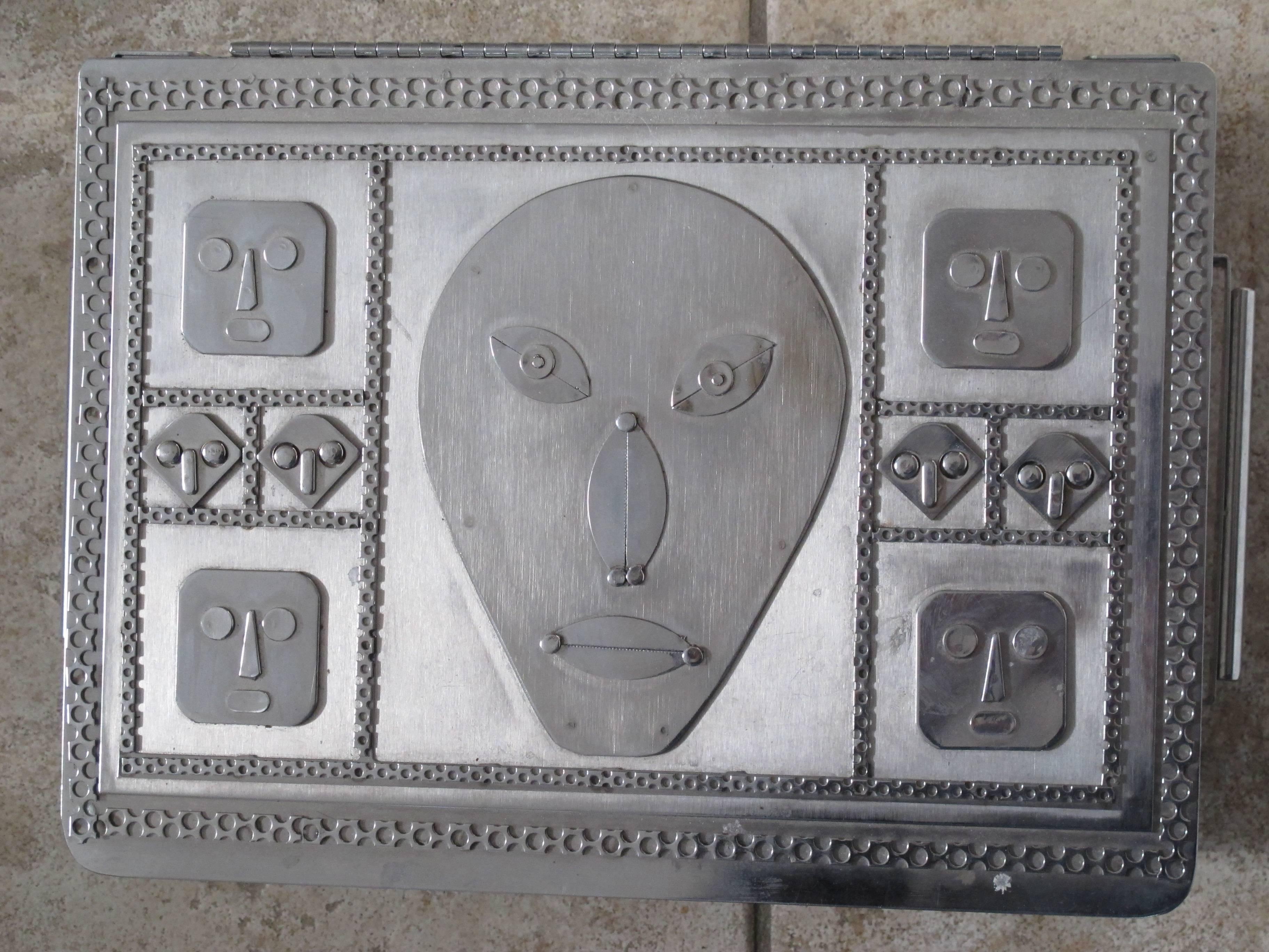 Jewelry box with mask faces of stainless steel by Stanley Szwarc.