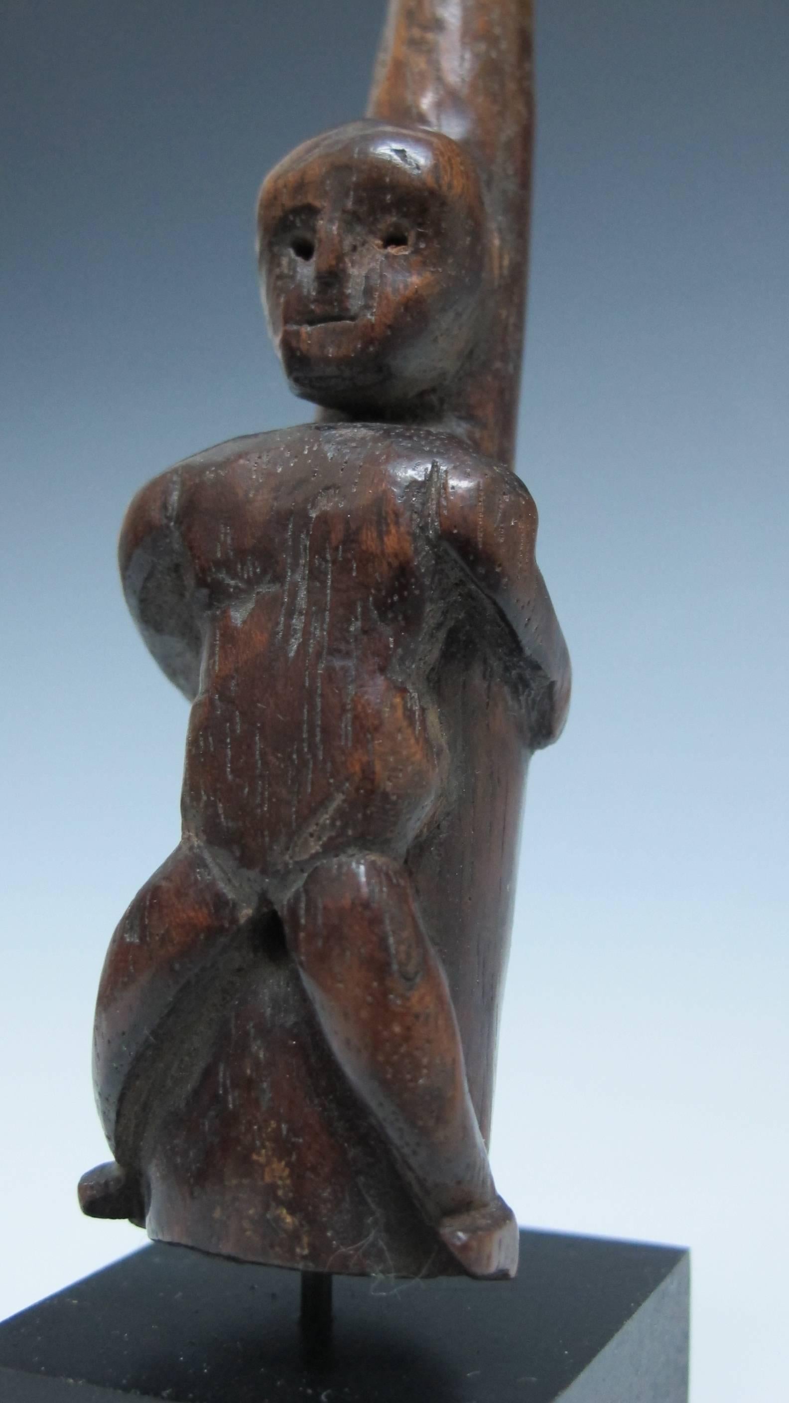Unusual carved wood figure laying on a bottle shaped smoking piece with arms and legs pulled back provocatively with small opening between the legs. The top narrow end would be the mouthpiece. At the lower end there is an opening of 1/2 inch with a