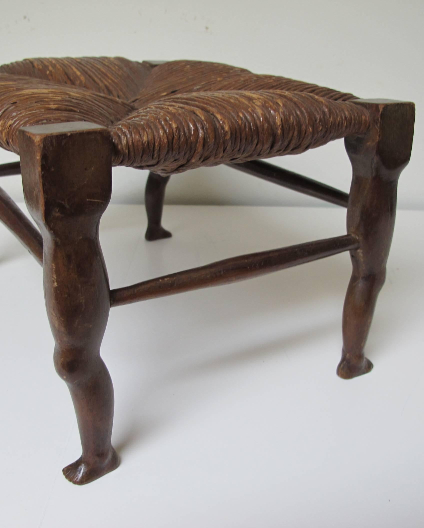 Finely carved small stool with shapely legs and original rush seat. The stool is cat sized for sleeping on and carved and mortised mahogany with stained nut brown finish.
Being a leg man this folk piece was irresistible.
