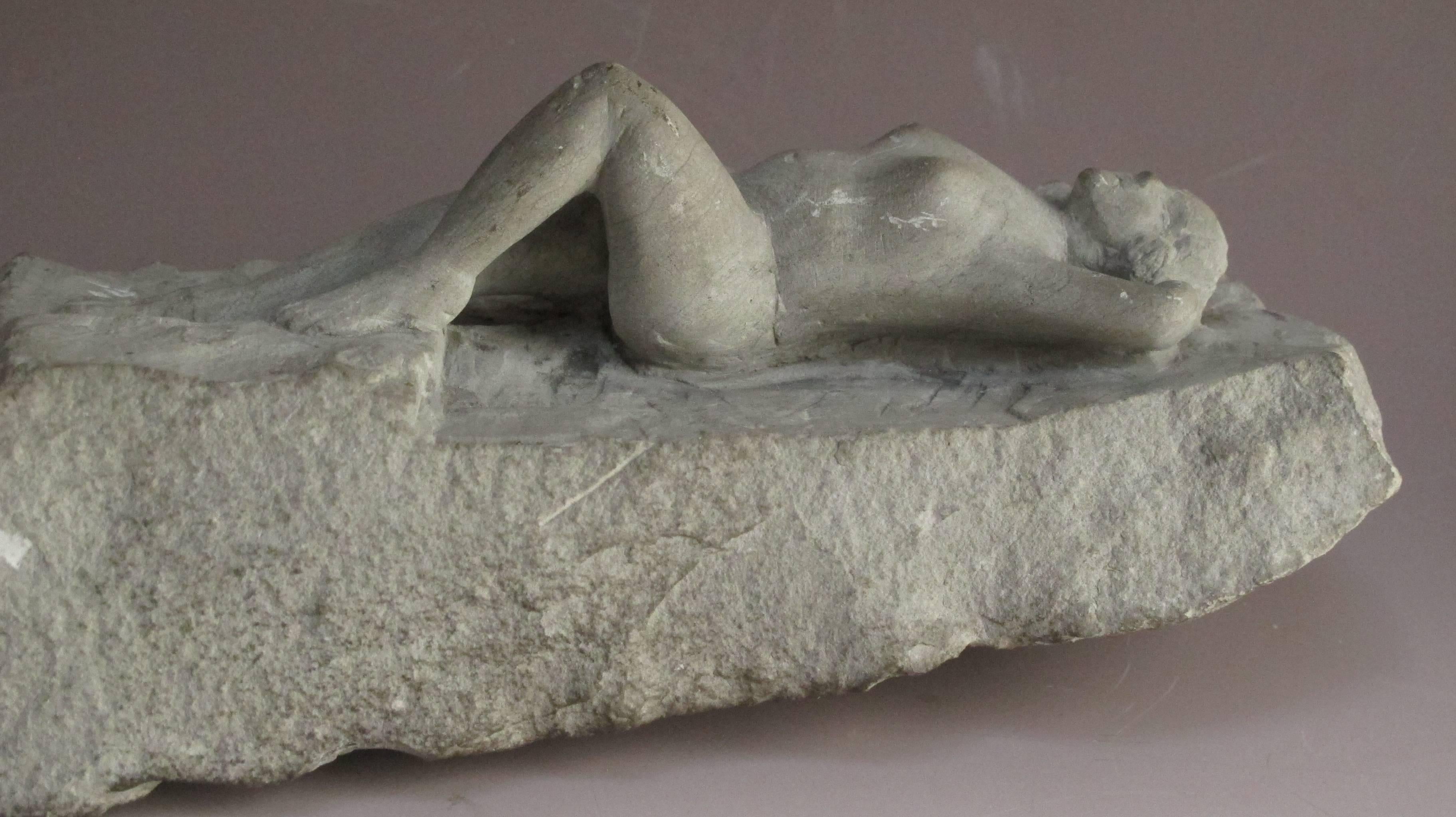 Nude woman carved for a rough piece of stone in a sensuous manner by an unknown artist.