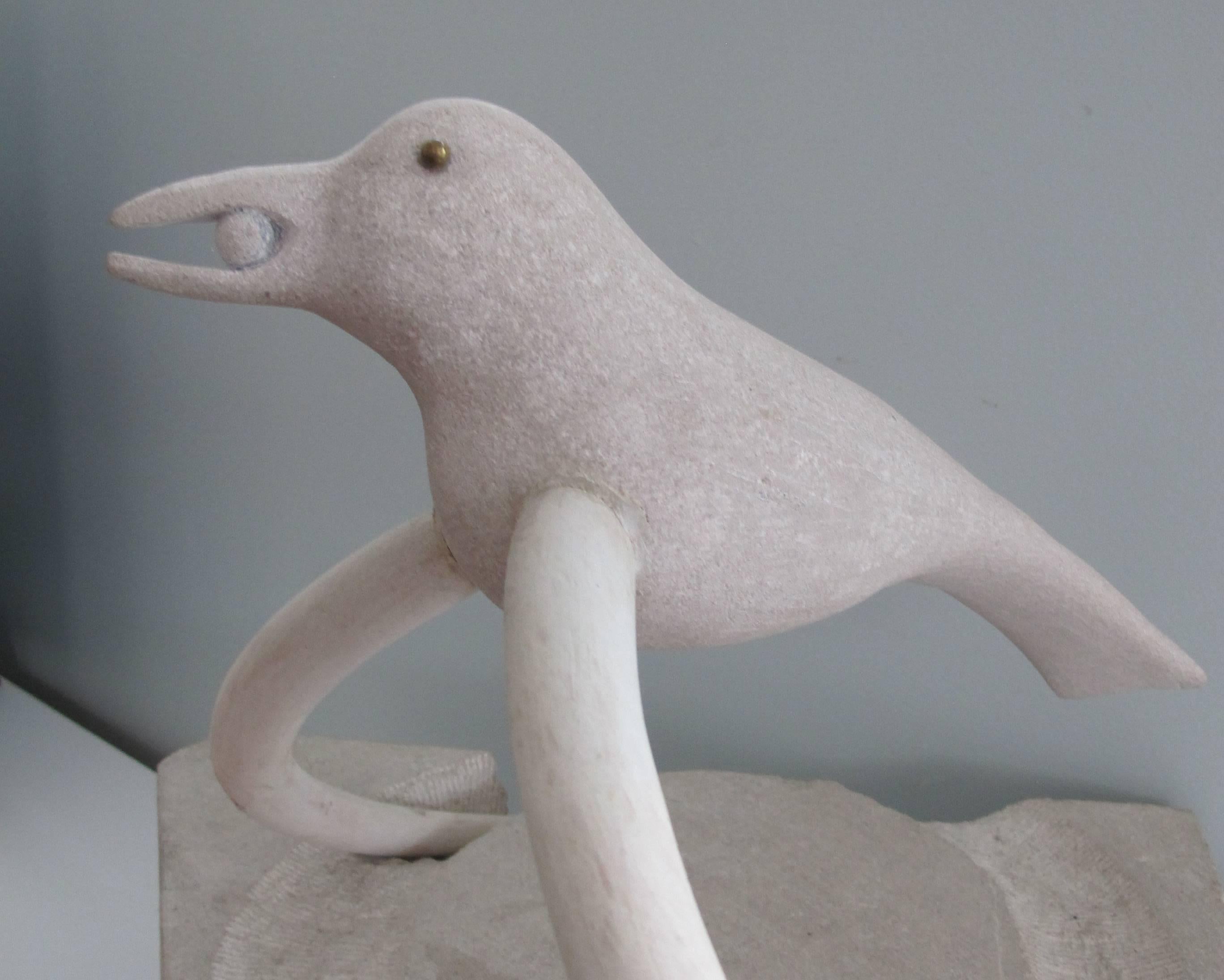 Tina White Anton is an artist working in carved and assembled limestone. This piece is a carved bird abstracted in relation to the stone ground and supported by a pair of tusks worked from rattan and joined to the bird. The relationship of the bird