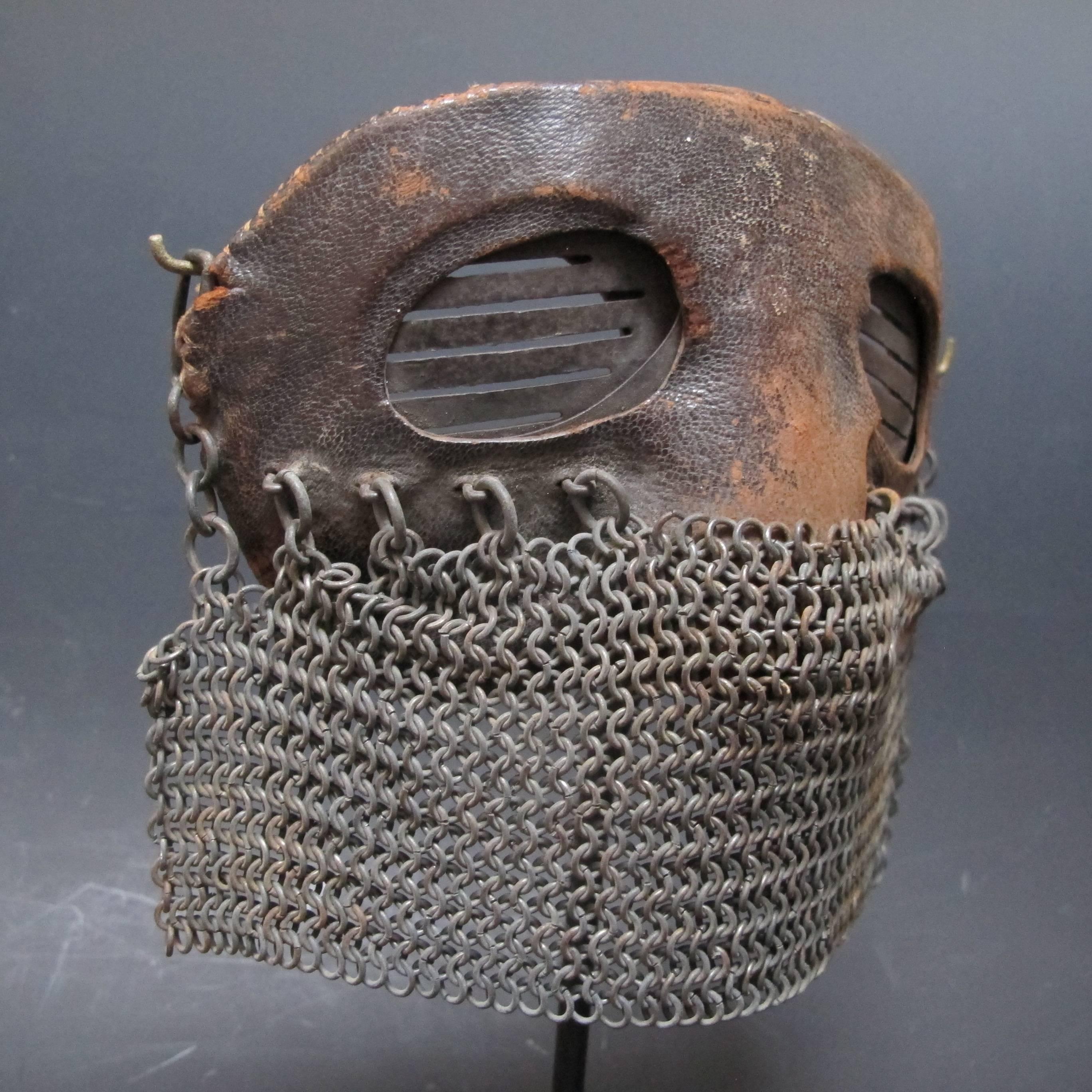 Rare face mask for protection designed for use on a tank in WWI. A man in the tank wearing a helmet would need to stick his head out at some point. The mask made of Sheffield hardened iron covered with leather and having a mouth veil of chain mail