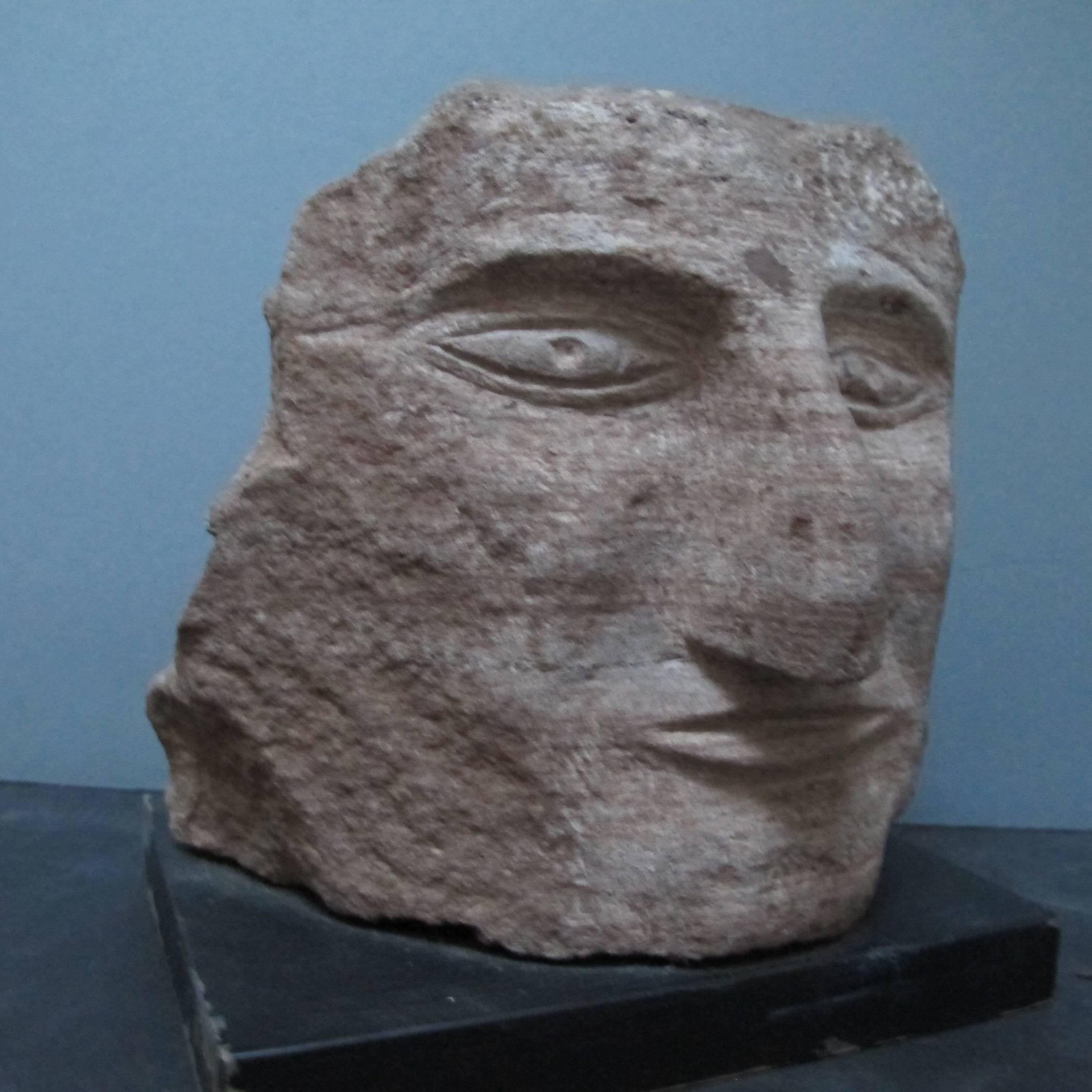 Ted Ludwiczak was known for carving numerous stone sculptures of stone heads. His home became an environment that has been written about in different publications from Raw Vision to Folk Art Messenger to the New York Times.
The sculpture comes with