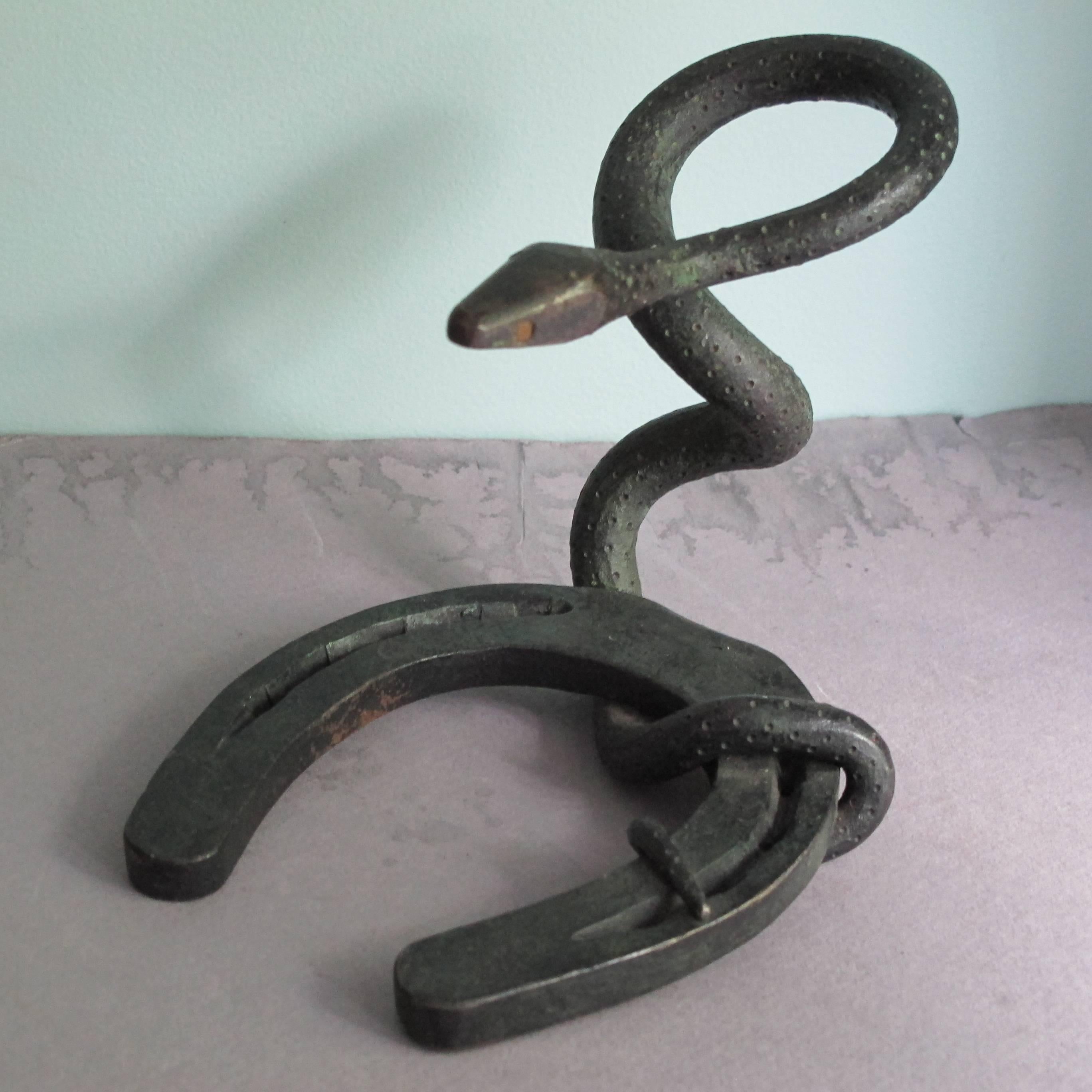 The art of the blacksmith in a nonfunctional sculpture probably made as a gift. After making endless utilitarian pieces of iron work. The unknown creator has formed the iron into a fluid form.