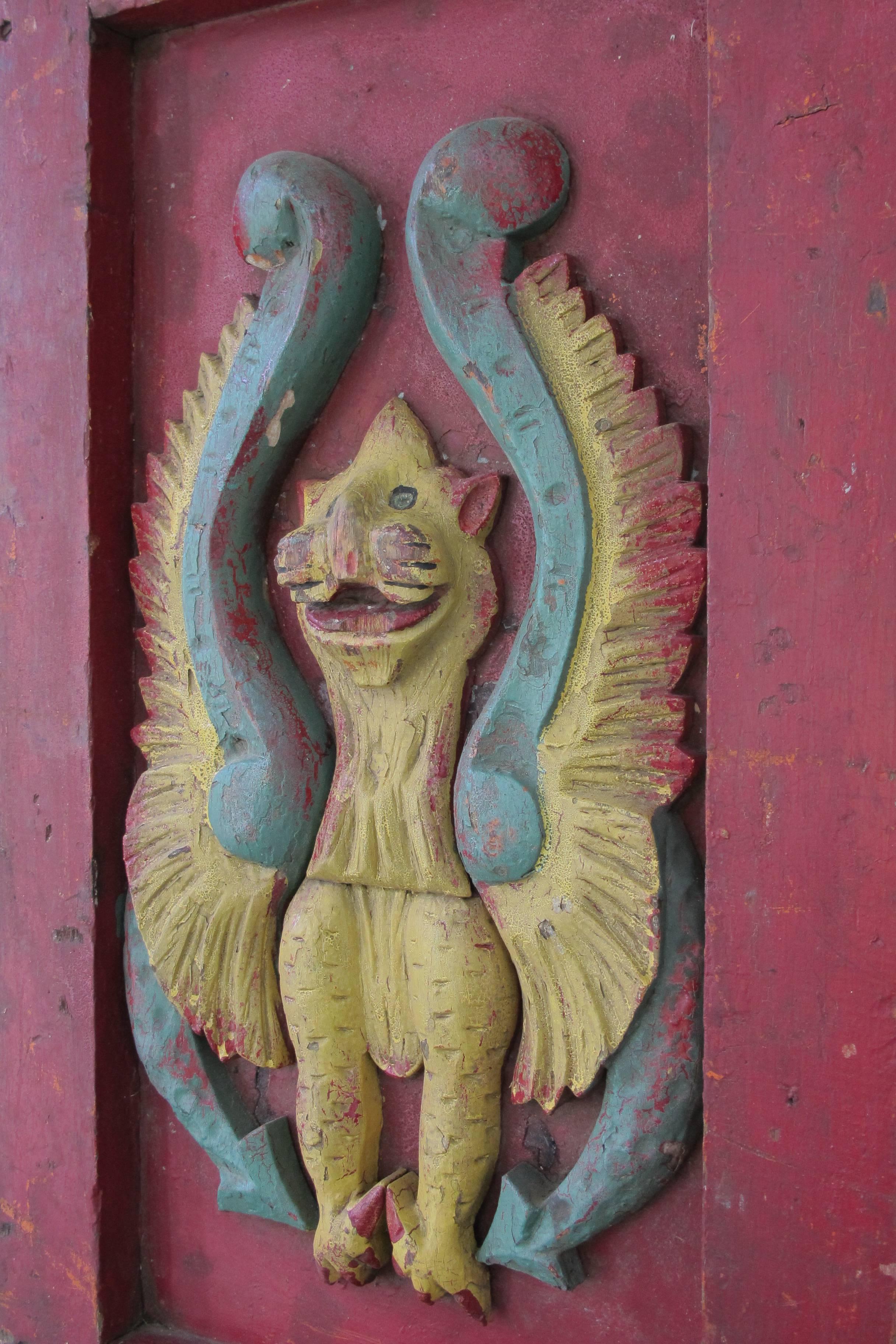 A painted wood panel from an early carousel with a mythological griffin. Carnival and carousel decorations were made to be exotic and fanciful as this one. The griffin is in deep relief and enhance by bright park paint.