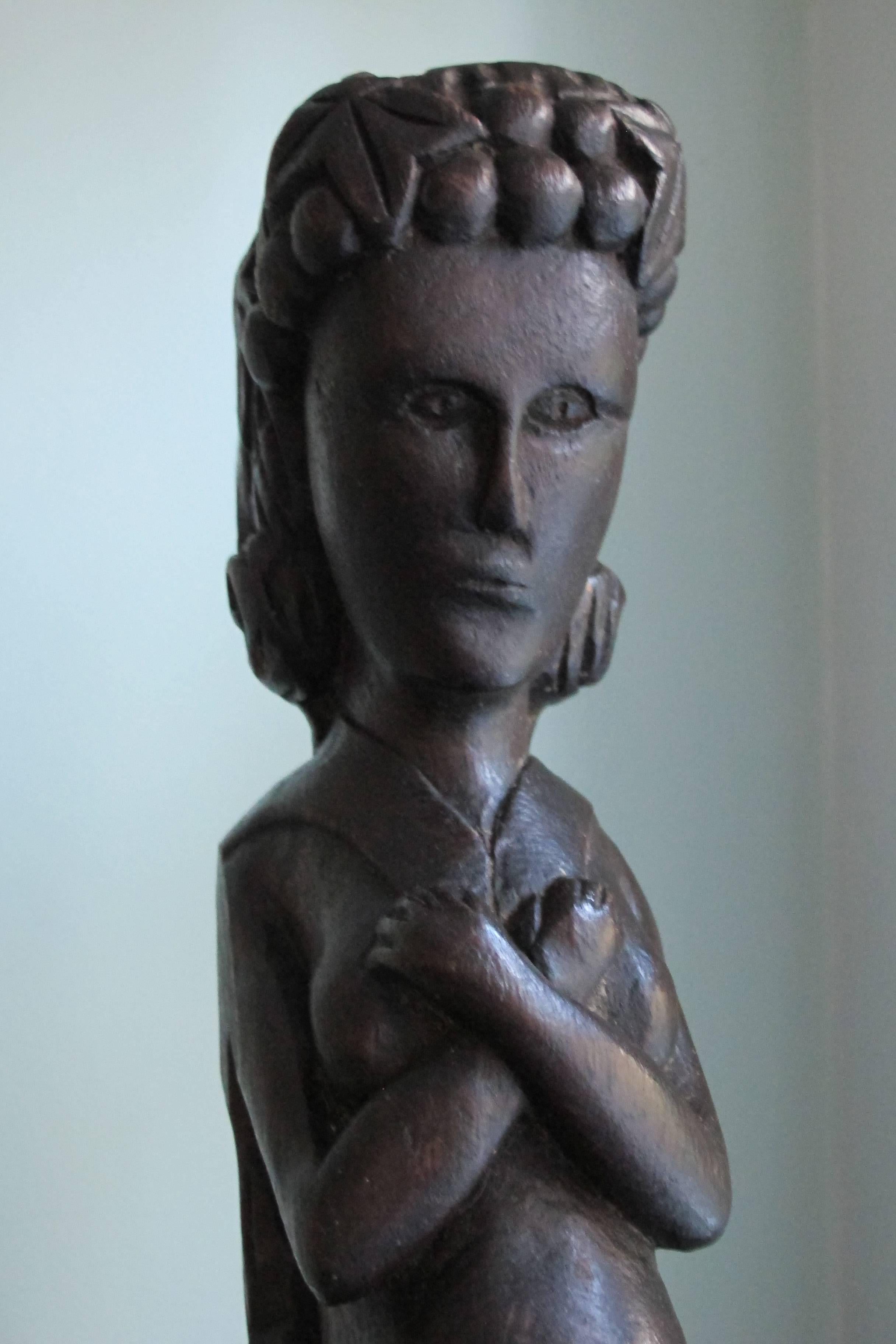 Carving that may have been architectural or from a piece of fanciful furniture. The arresting female figure has her arms crossed over her chest with a downward gaze.
The carving has a deep brown stain and smooth surface.
